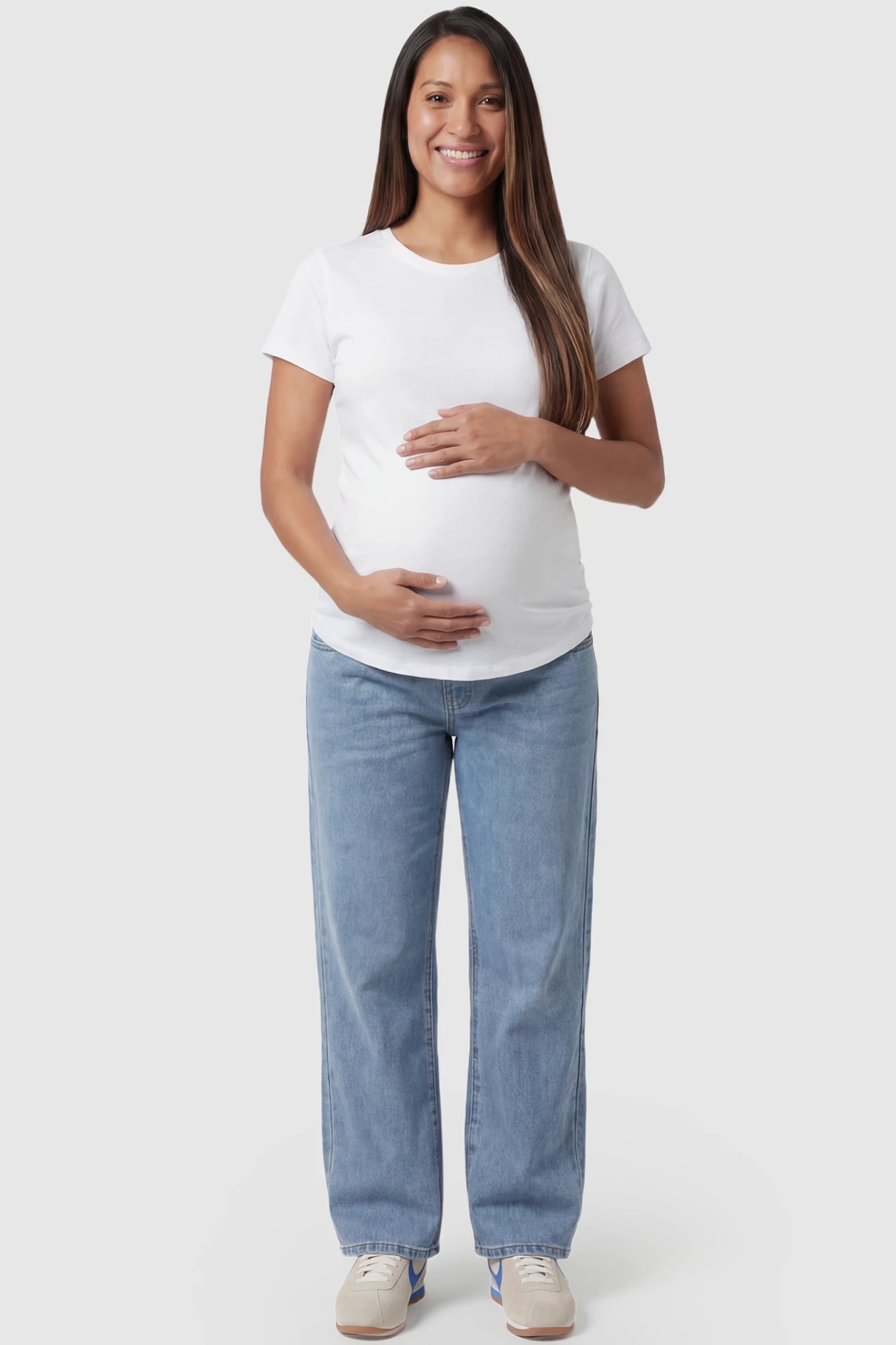 Denim straight-leg maternity jeans in light blue wash featuring full belly panel support and relaxed fit on pregnant model.