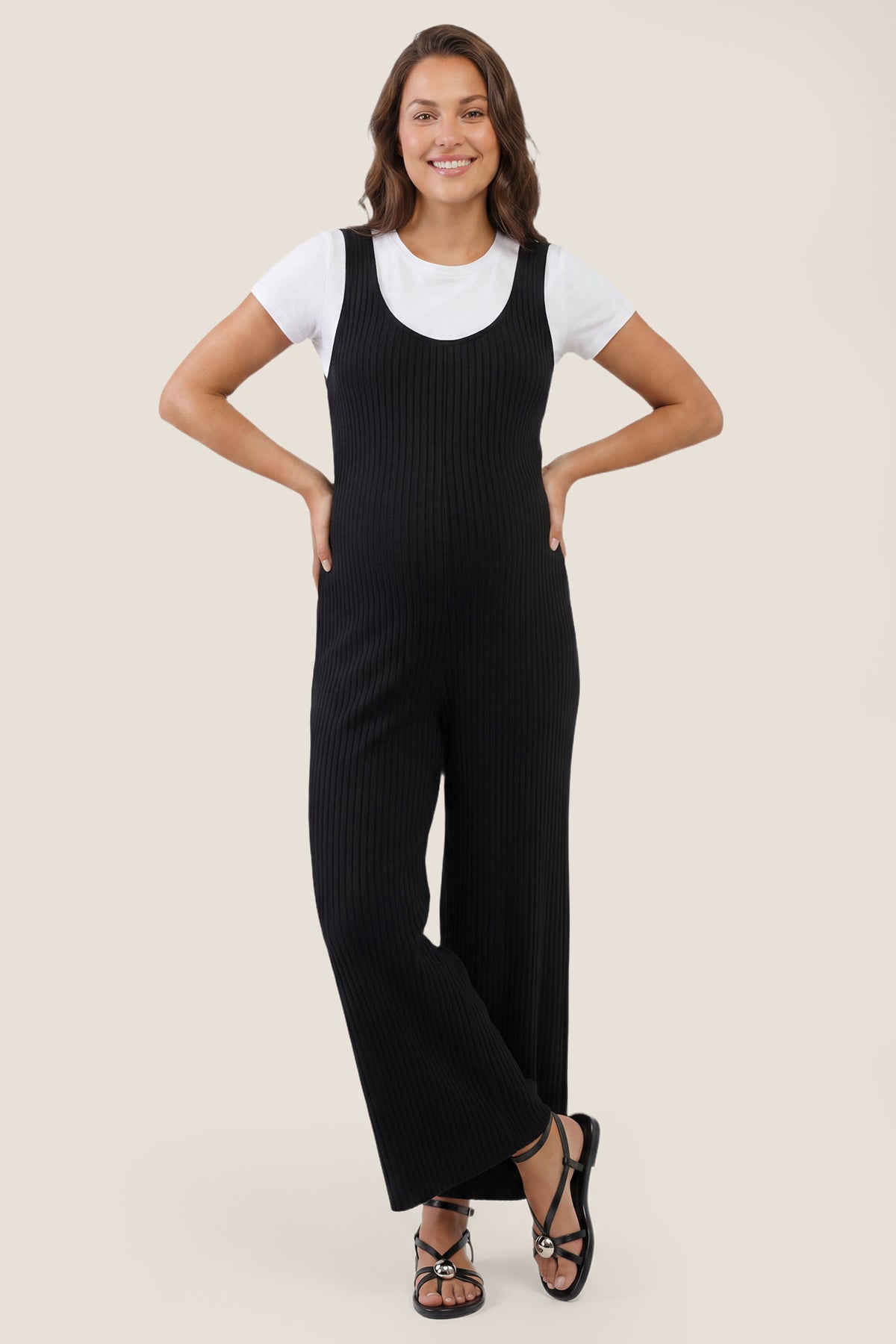 Ribbed sleeveless wide-leg maternity jumpsuit in black with sleeveless ribbed design, front view on pregnant model