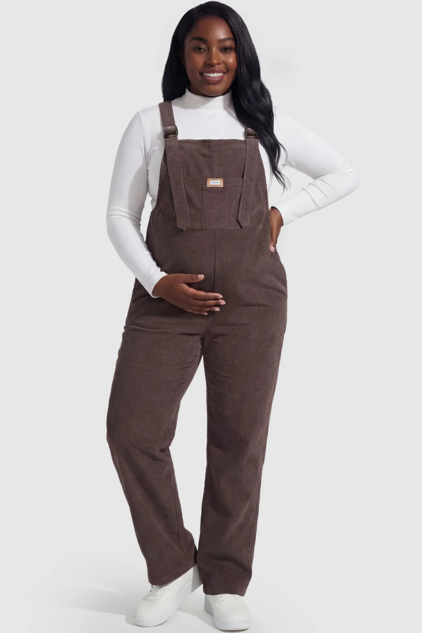 Wide leg side stretch panel maternity overalls in brown featuring flexible side panels on a pregnant model