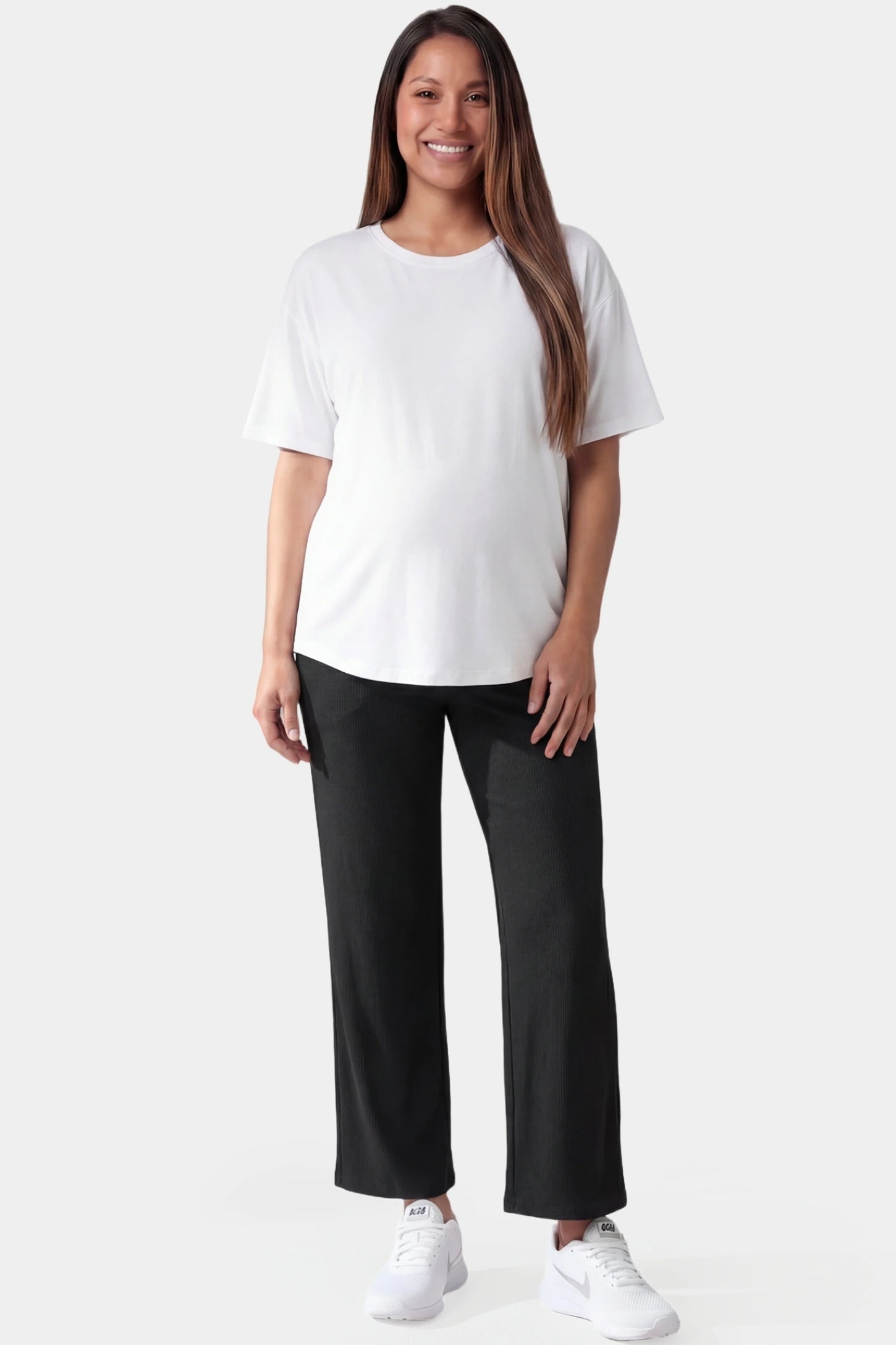 Adjustable waistband high waisted wide-leg maternity pants in black featuring relaxed flowing silhouette in full body view on a pregnant model