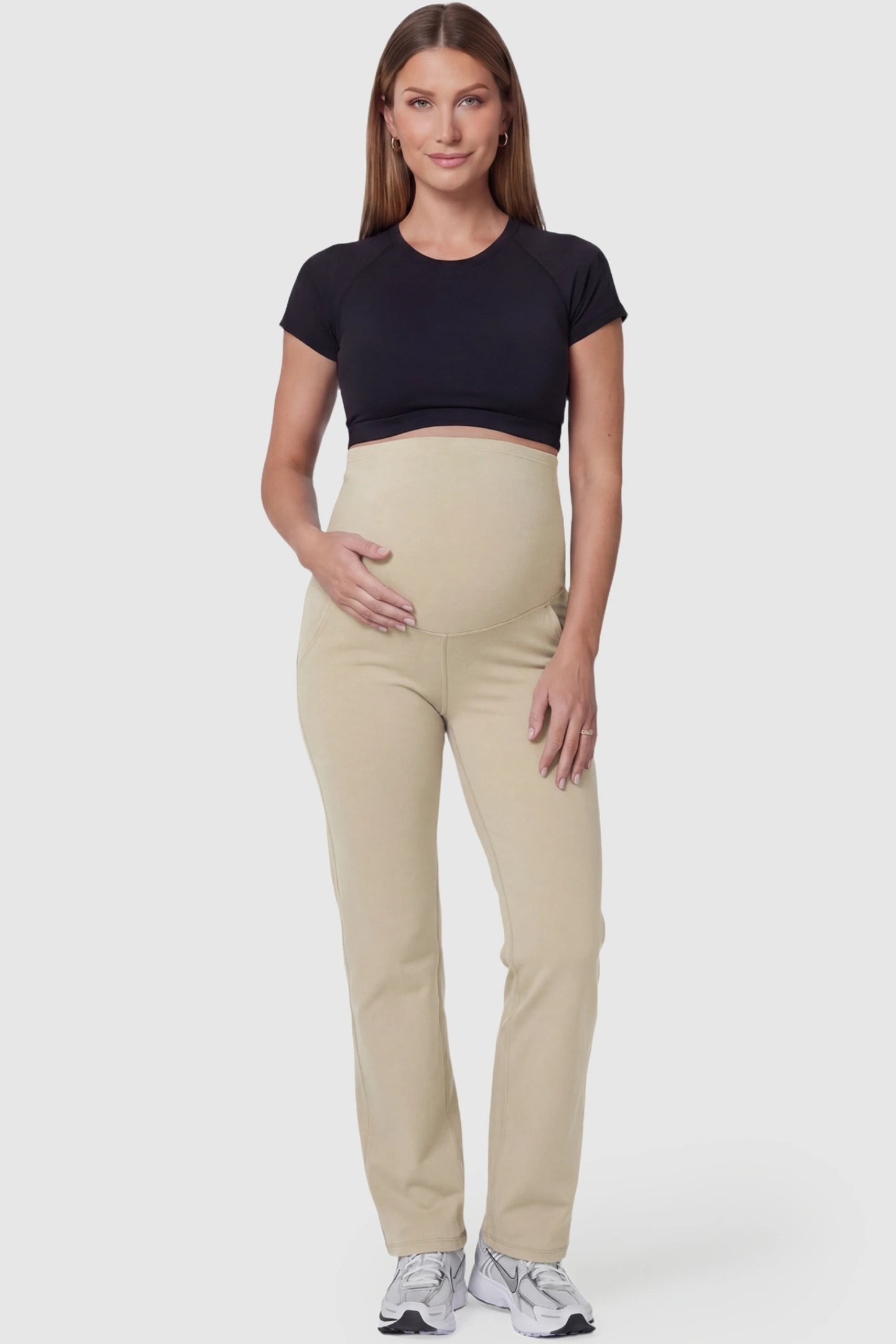 Suede-finish high-waisted straight leg yoga maternity pants in beige with straight leg cut, full body on pregnant model