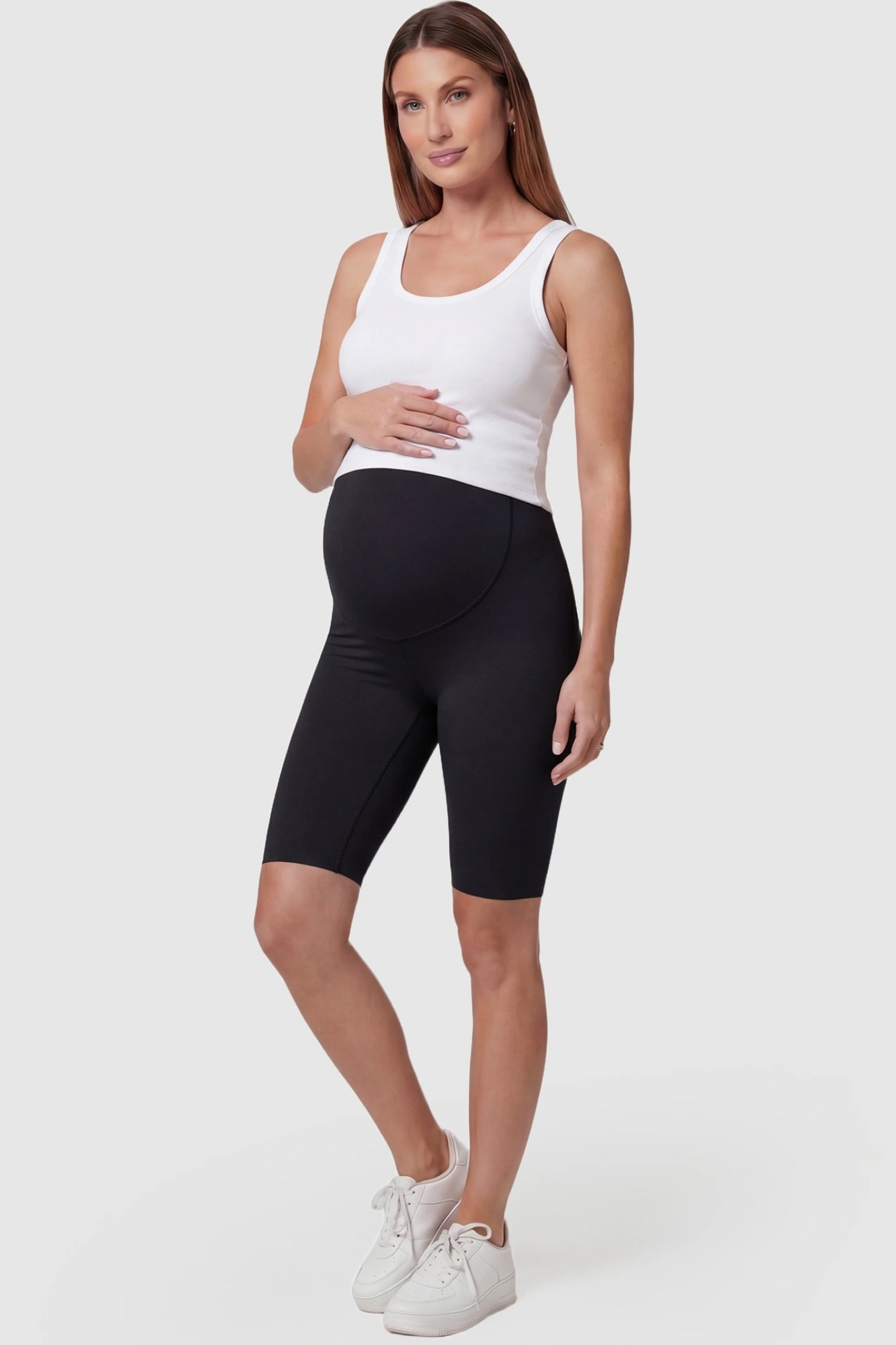 High-waist belly support slim fit shark maternity shorts in black with slim silhouette, full body on pregnant model