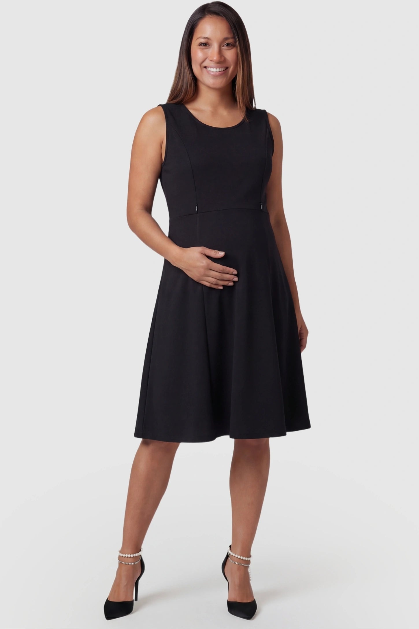 Zip-Up Nursing Access A-Line Maternity Tank Dress in Black featuring a scoop neckline on a pregnant model, front view.