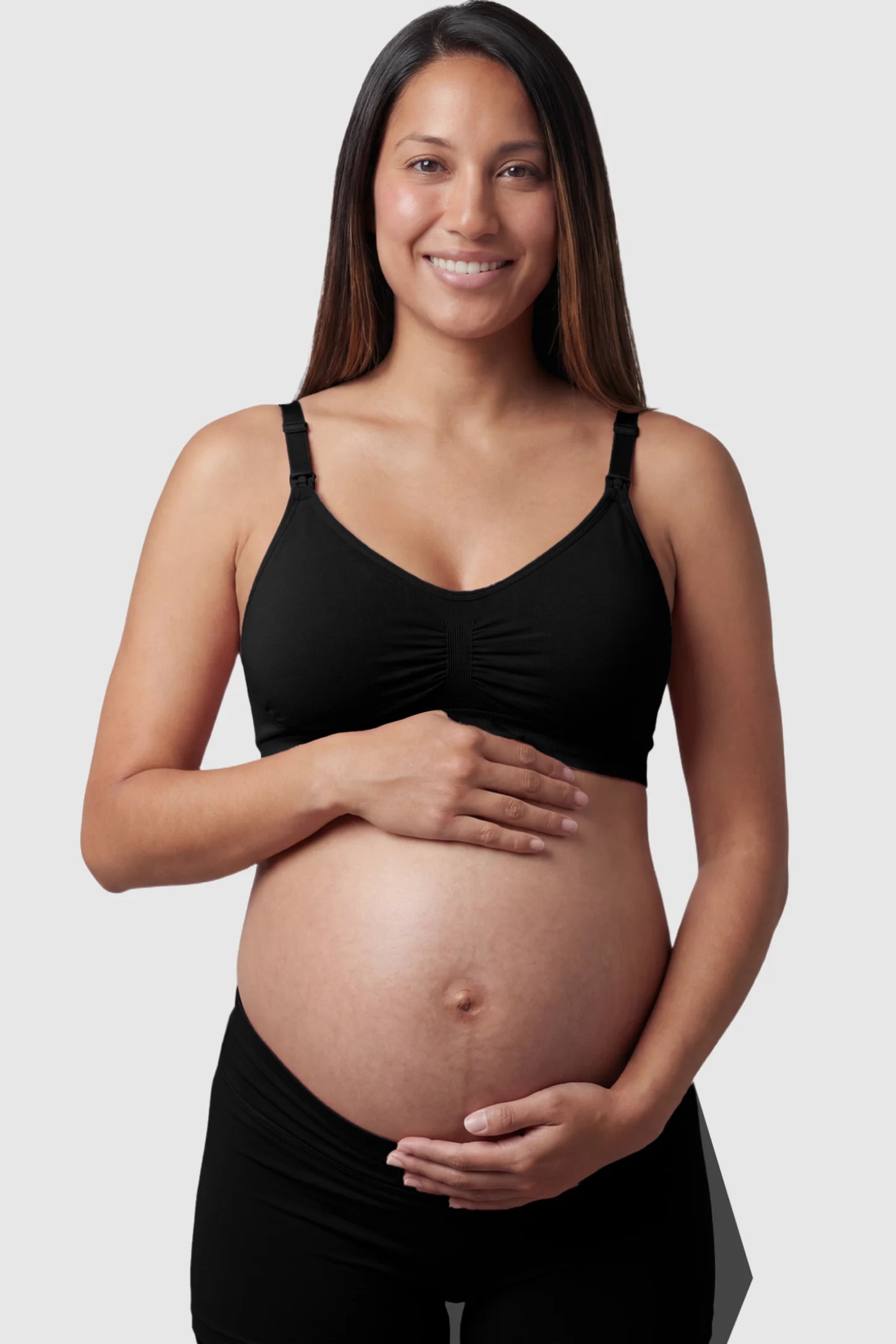 Seamless Ruched Front Maternity Nursing Bra in black featuring ribbed fabric and drop-down clips on a pregnant model showing front.