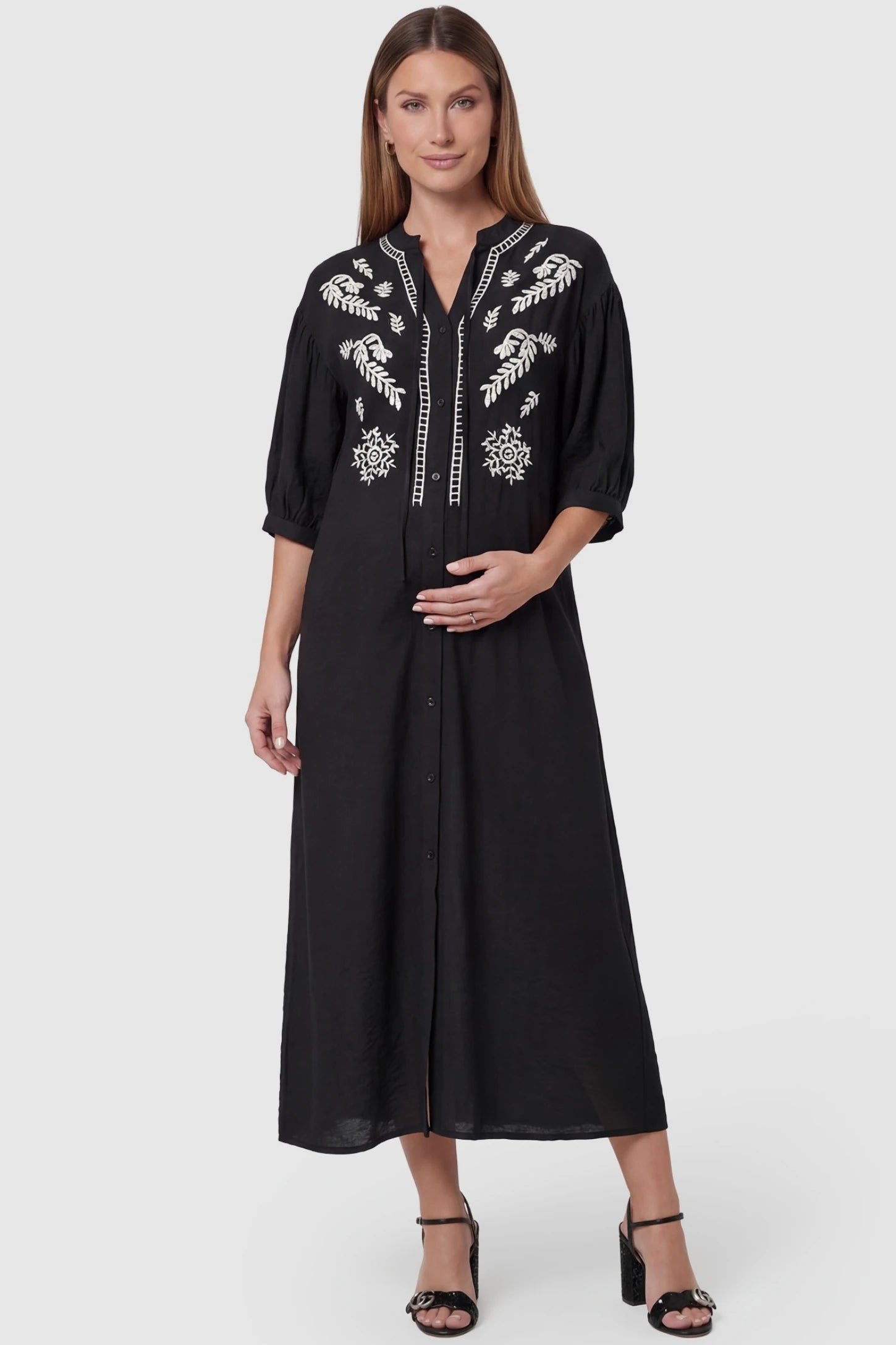 Embroidered Notched Half Sleeve Maternity Midi Dress in Black featuring white floral embroidery on a pregnant model.