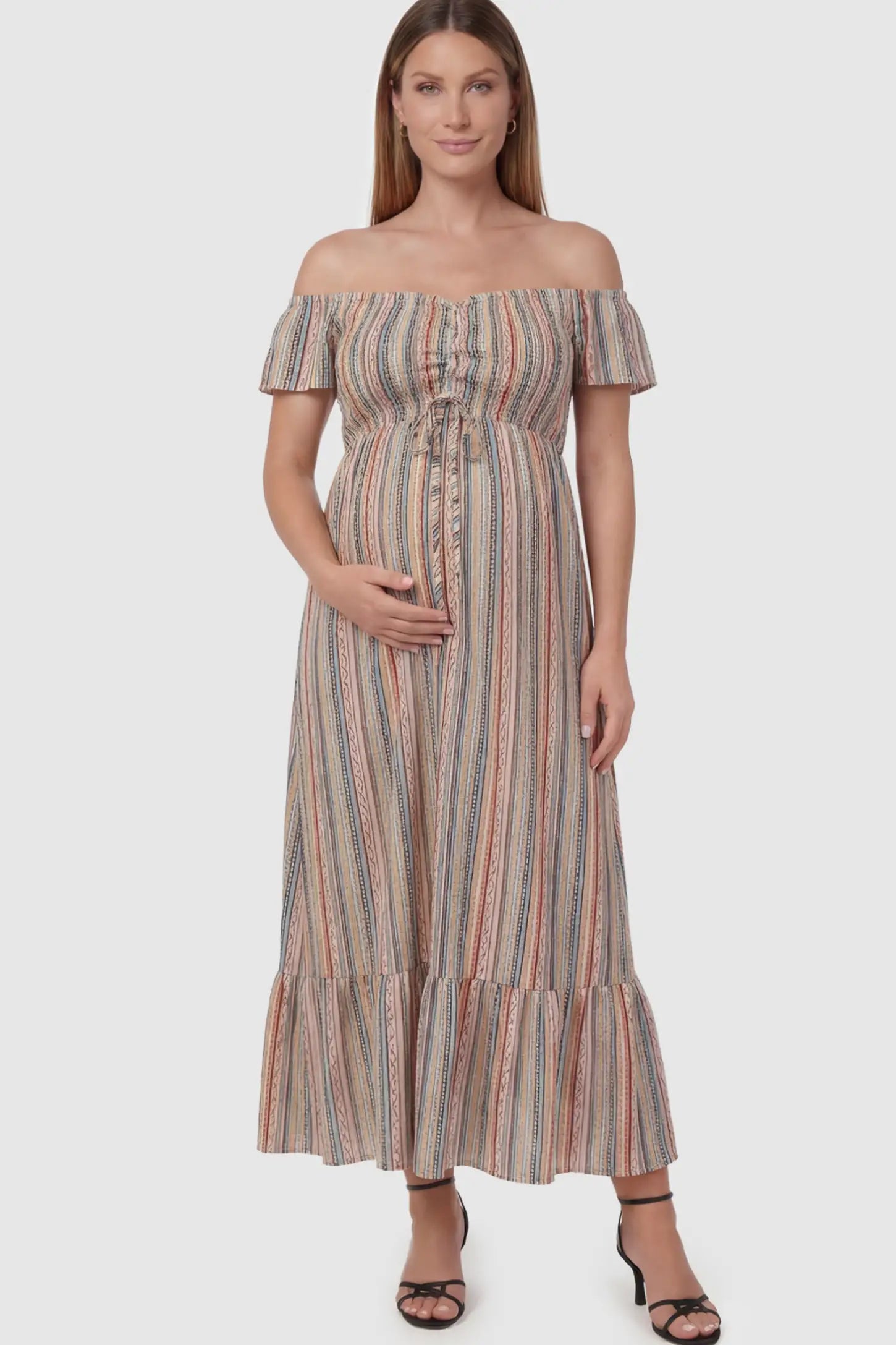 Striped Off-the-Shoulder Ruffle Hem Maternity Maxi Dress in multi colors featuring a flounced hem on a pregnant model.