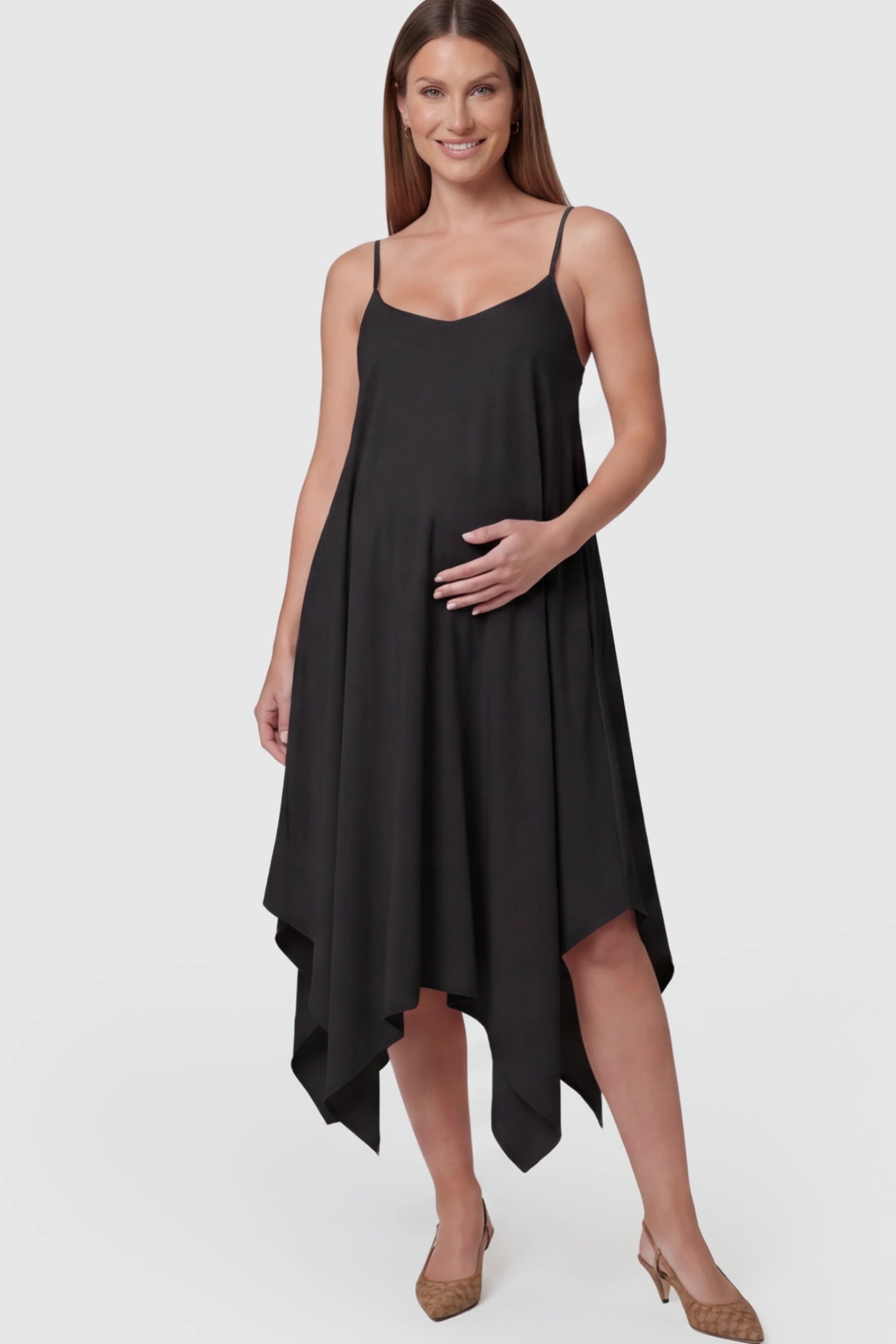 Spaghetti Strap Handkerchief Hem Maternity Midi Dress in Black featuring a scoop-neck on a pregnant model.