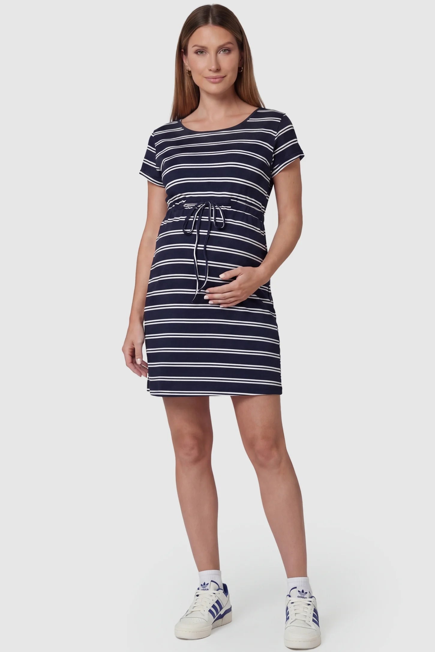 Nautical Striped Drawstring Waist Mini Maternity Dress in dark blue and white featuring a round neckline on a pregnant model.