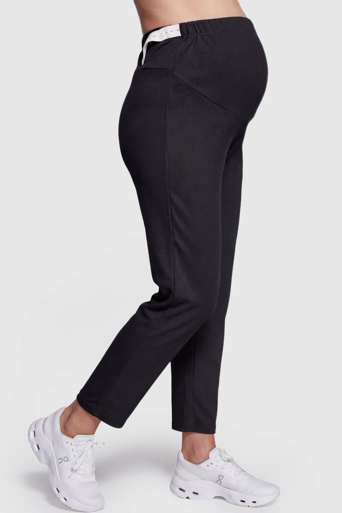 Straight Leg Maternity Pants in Black featuring an adjustable elastic waist on a pregnant model showing side.