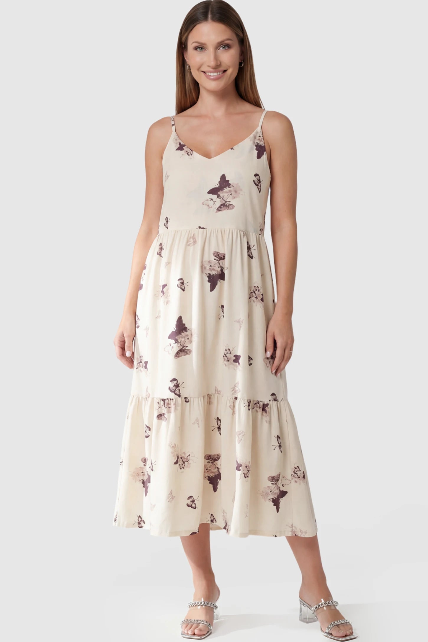 Butterfly Print Tiered Maternity Midi Dress in Beige Brown featuring a V-neckline and spaghetti straps on a pregnant model posing front.