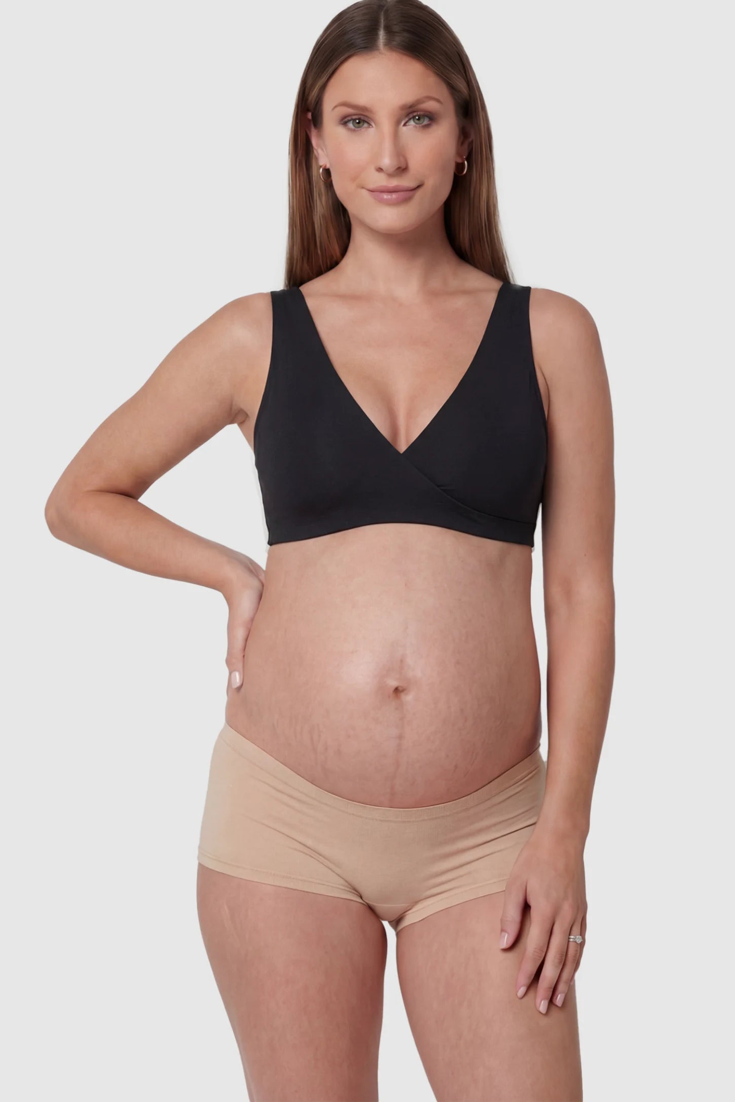 Cotton Blend Crossover Maternity Nursing Bra in Black featuring a wire-free wrap front on a pregnant model showing front.
