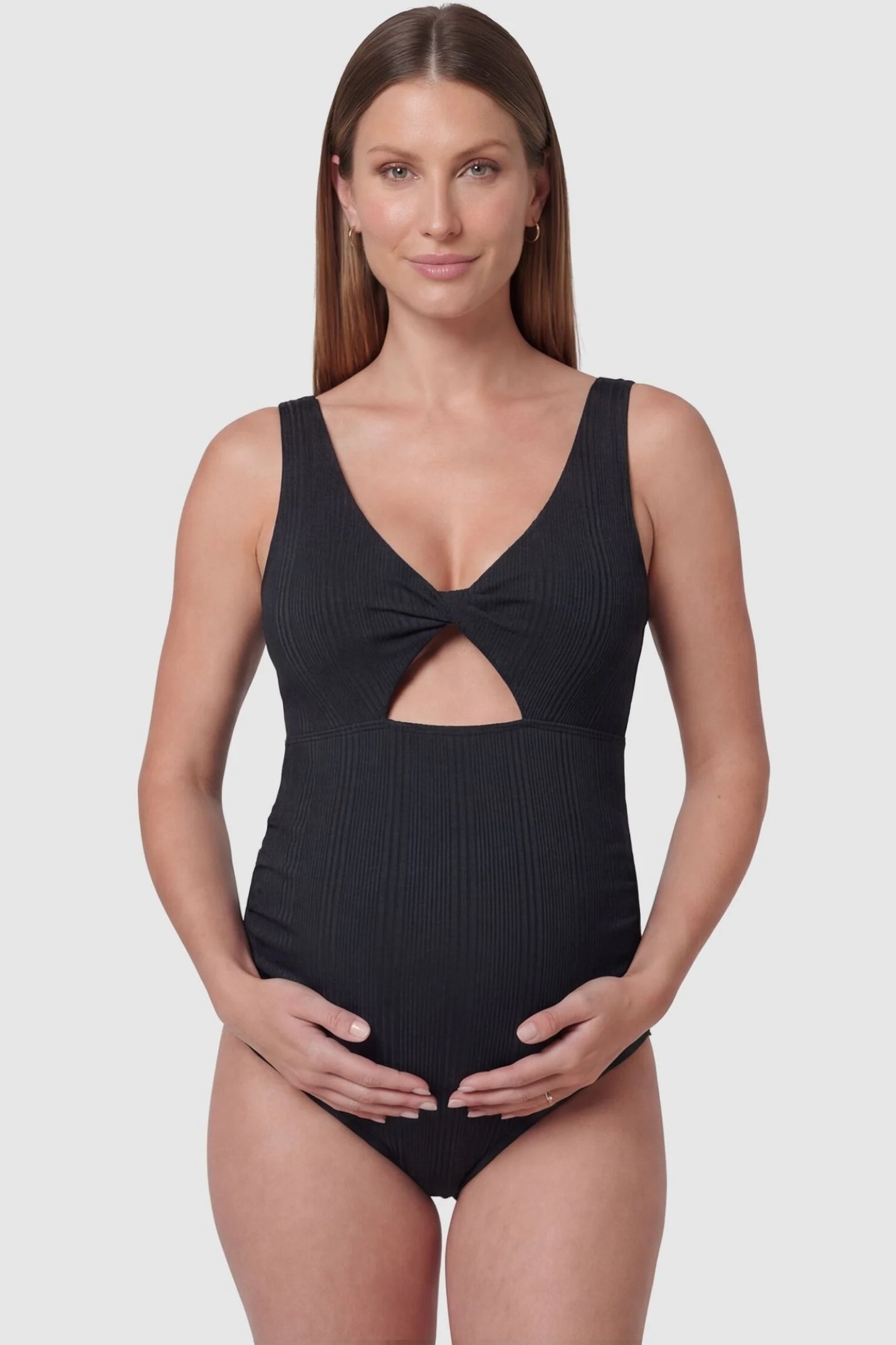 Cutout Twisted V-Neck Maternity Swimsuit in Black featuring a front view with a knotted bust on a pregnant model.