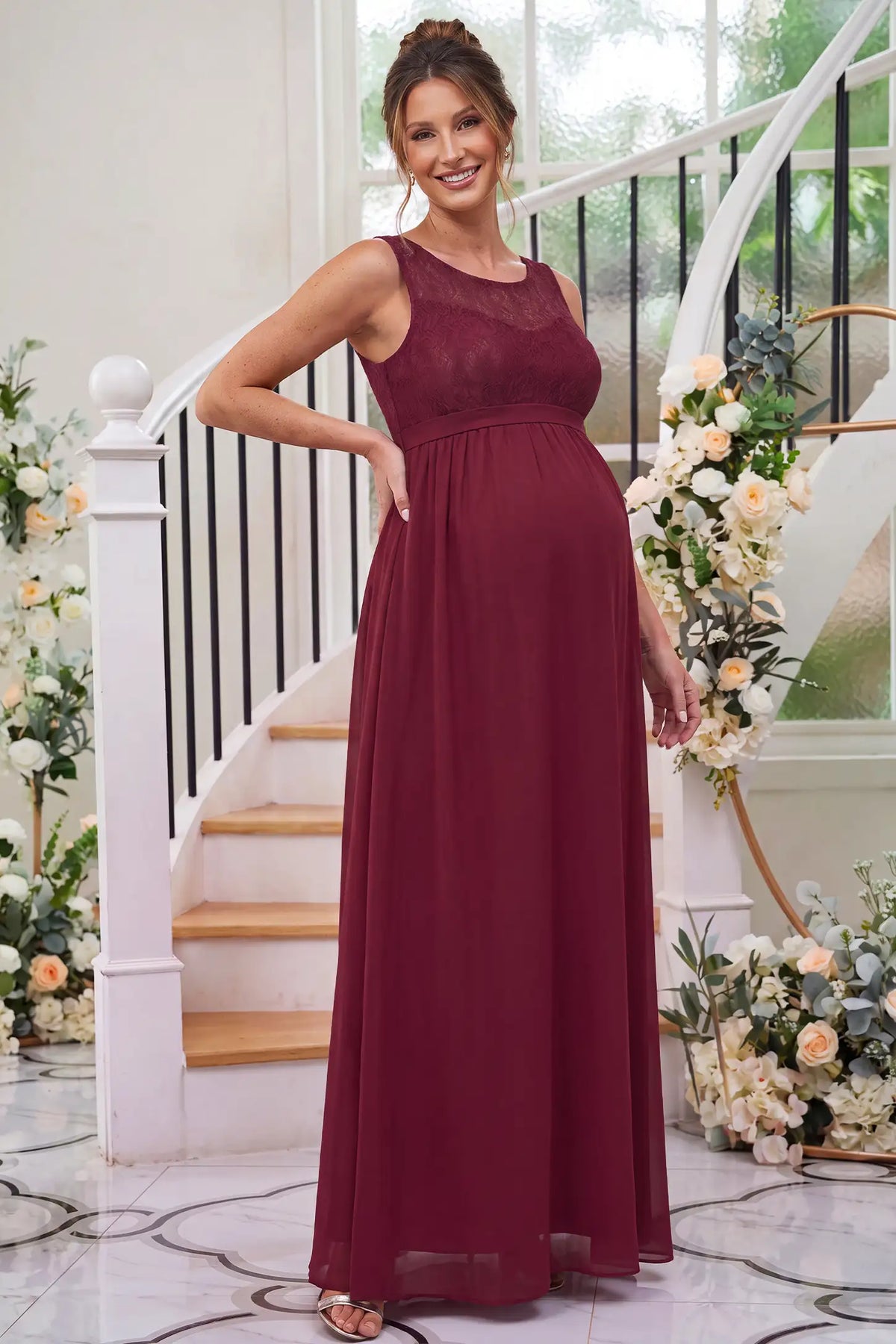 Floral Lace Sleeveless Maternity Maxi Dress in Burgundy featuring a flowing skirt on a pregnant model.