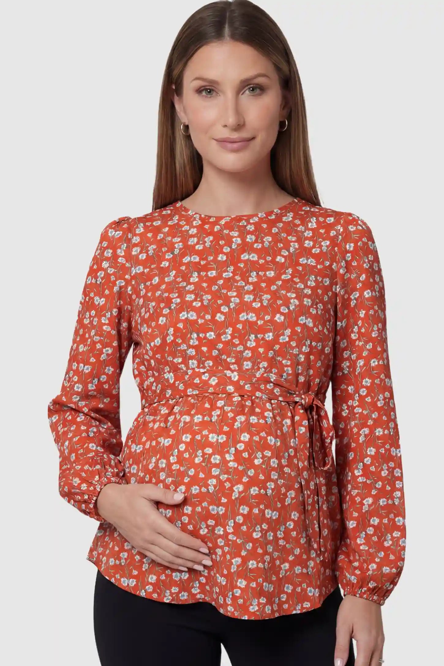 Floral Round Neck Babydoll Maternity Top in Red featuring an adjustable waist tie on a pregnant model showing front.