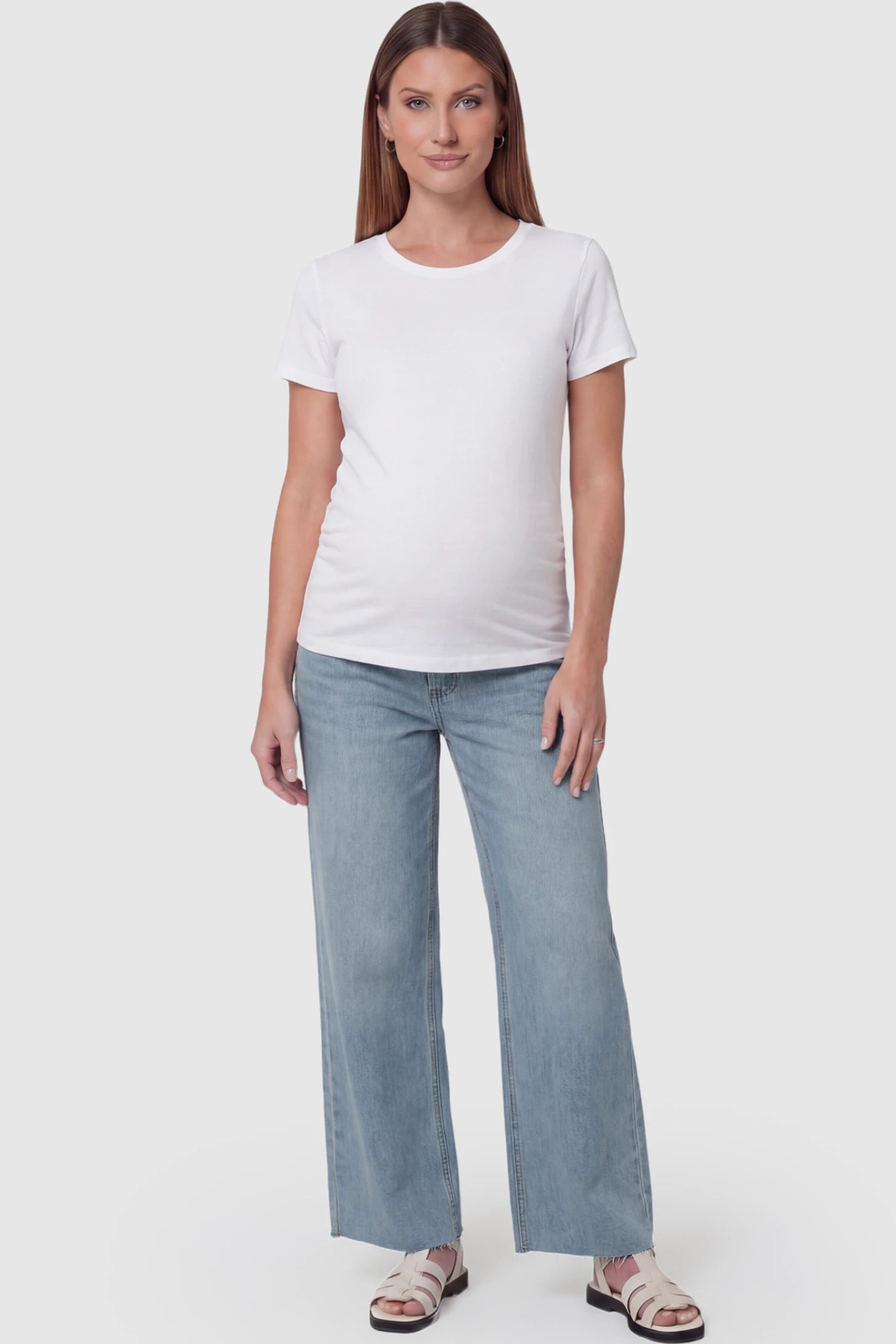 Full Panel Wide Leg Maternity Jeans in Light Blue featuring a seamless tummy-support band on a pregnant model facing front.