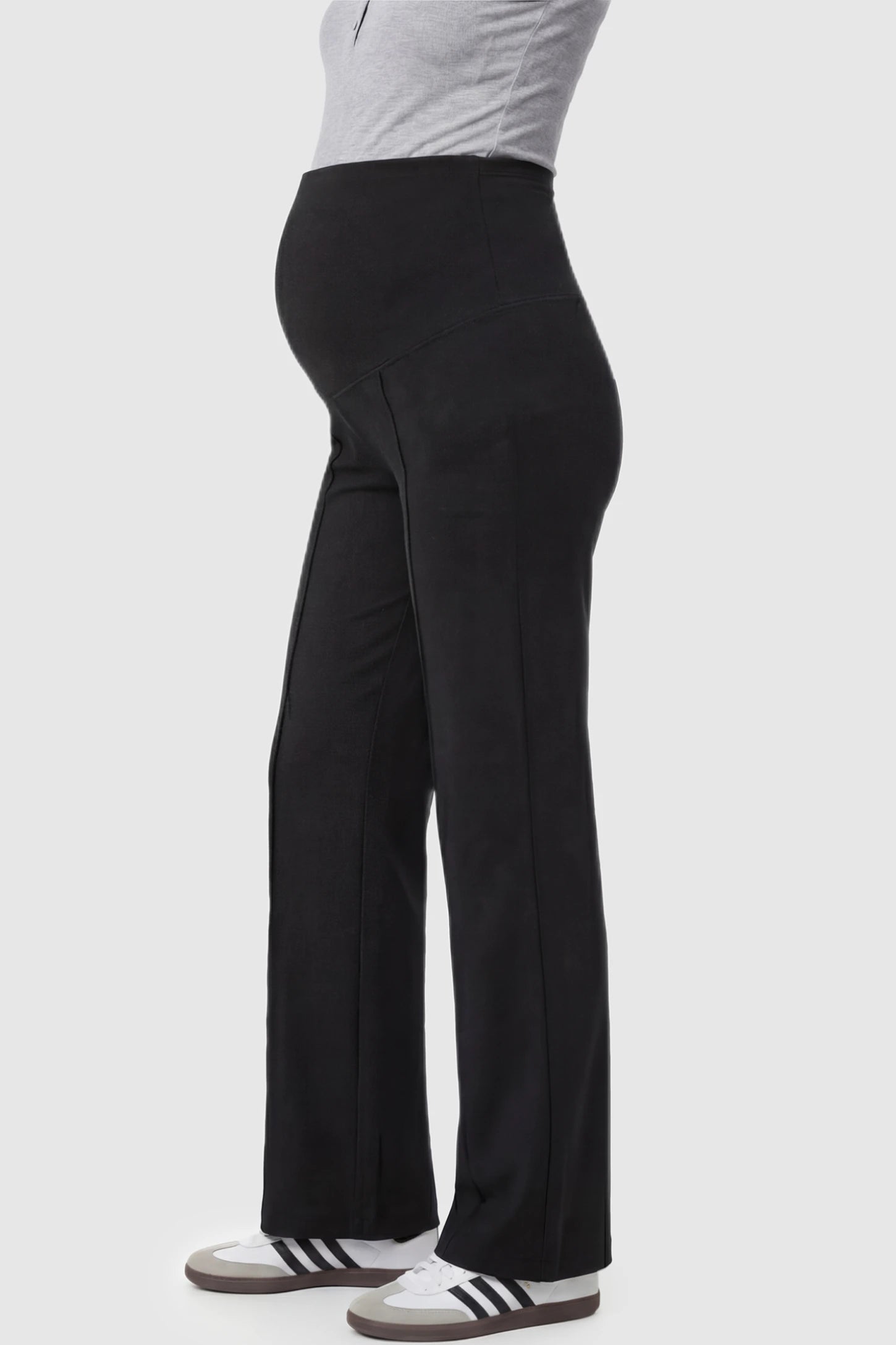 High-Stretch Wide Leg Pocketed Maternity Pants in Black featuring a seamless over-the-bump panel and side pocket on a pregnant model showing side.