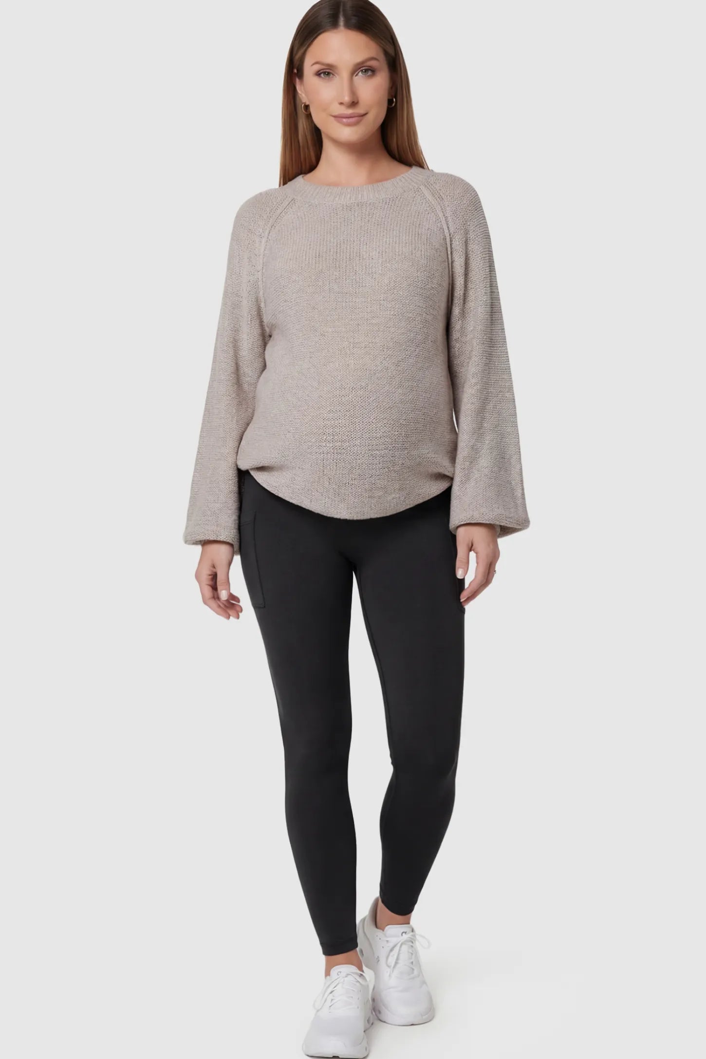 High-Waist Ankle-Length Pocketed Maternity Leggings in Black featuring a seamless waistband on a pregnant model posing front.