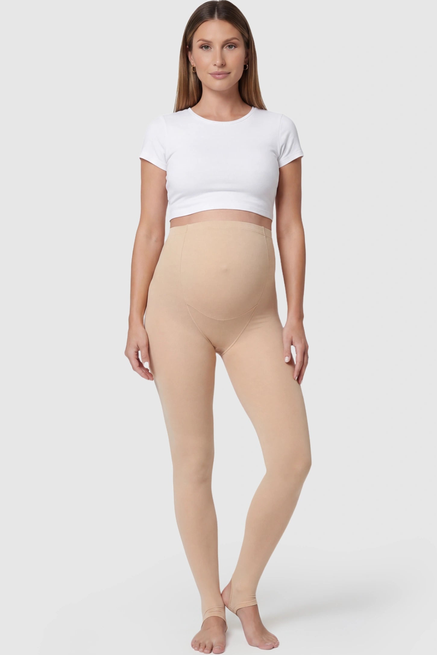 High Waist Fleece-Lined Stirrup Maternity Leggings in Skin Tone featuring a supportive over-the-belly panel on a pregnant model posing front.