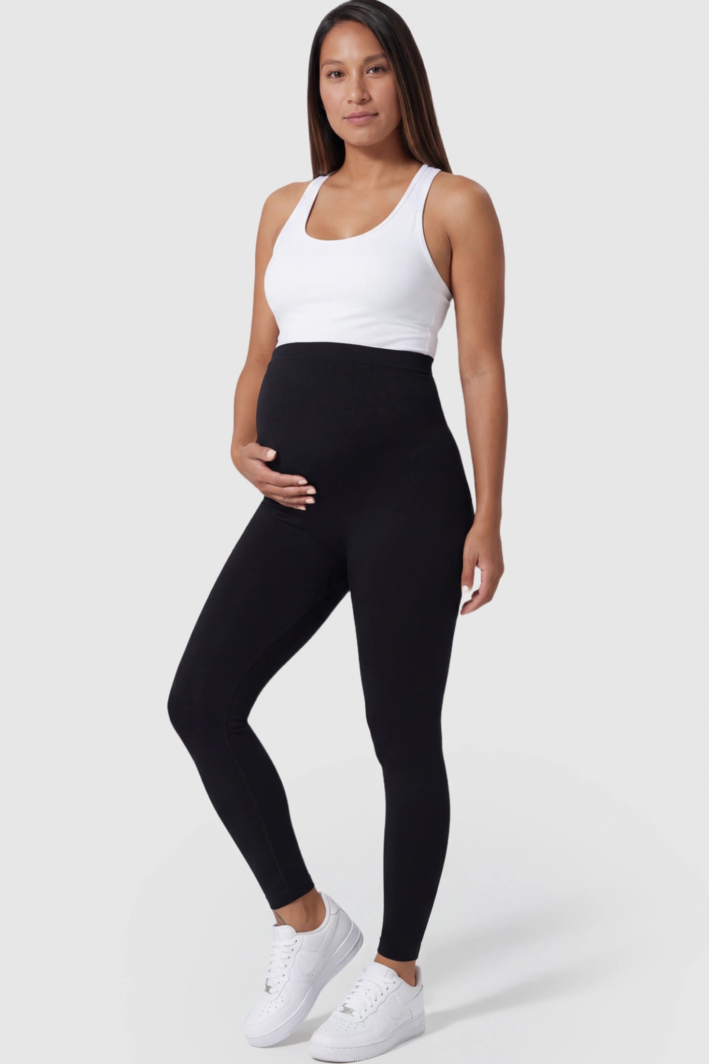 High Waist Seamless Full-Length Maternity Leggings in Black featuring a supportive waistband on a pregnant model posing front.
