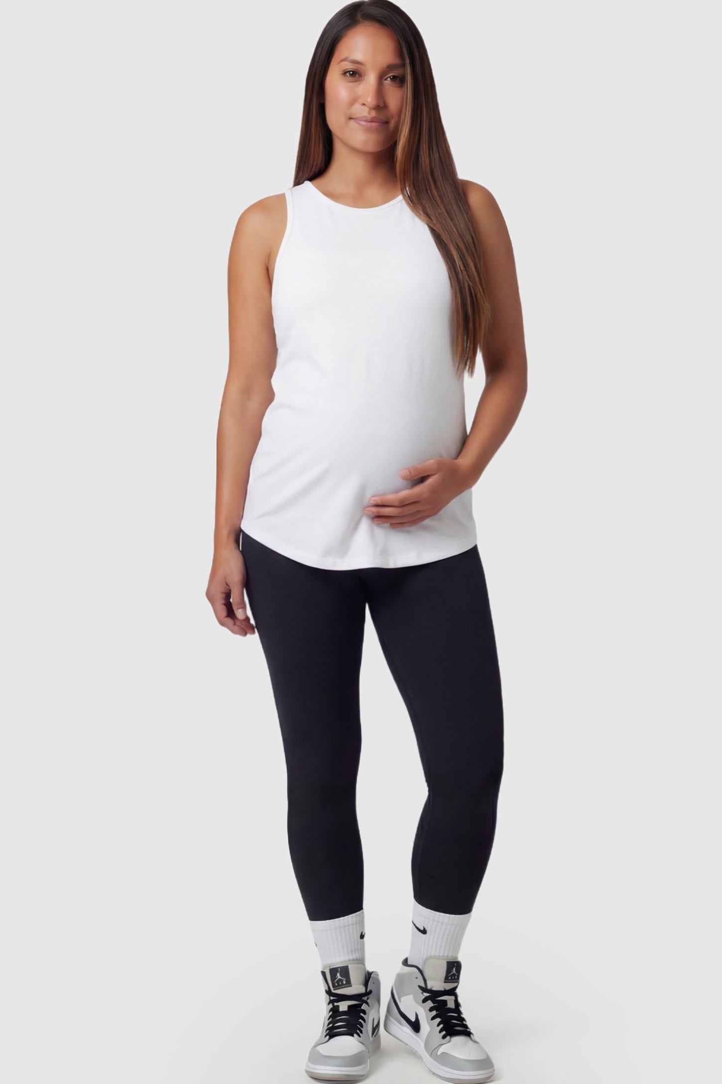 High Waist Slim Fit Maternity Leggings in Black featuring a seamless full-panel on a pregnant model front view.