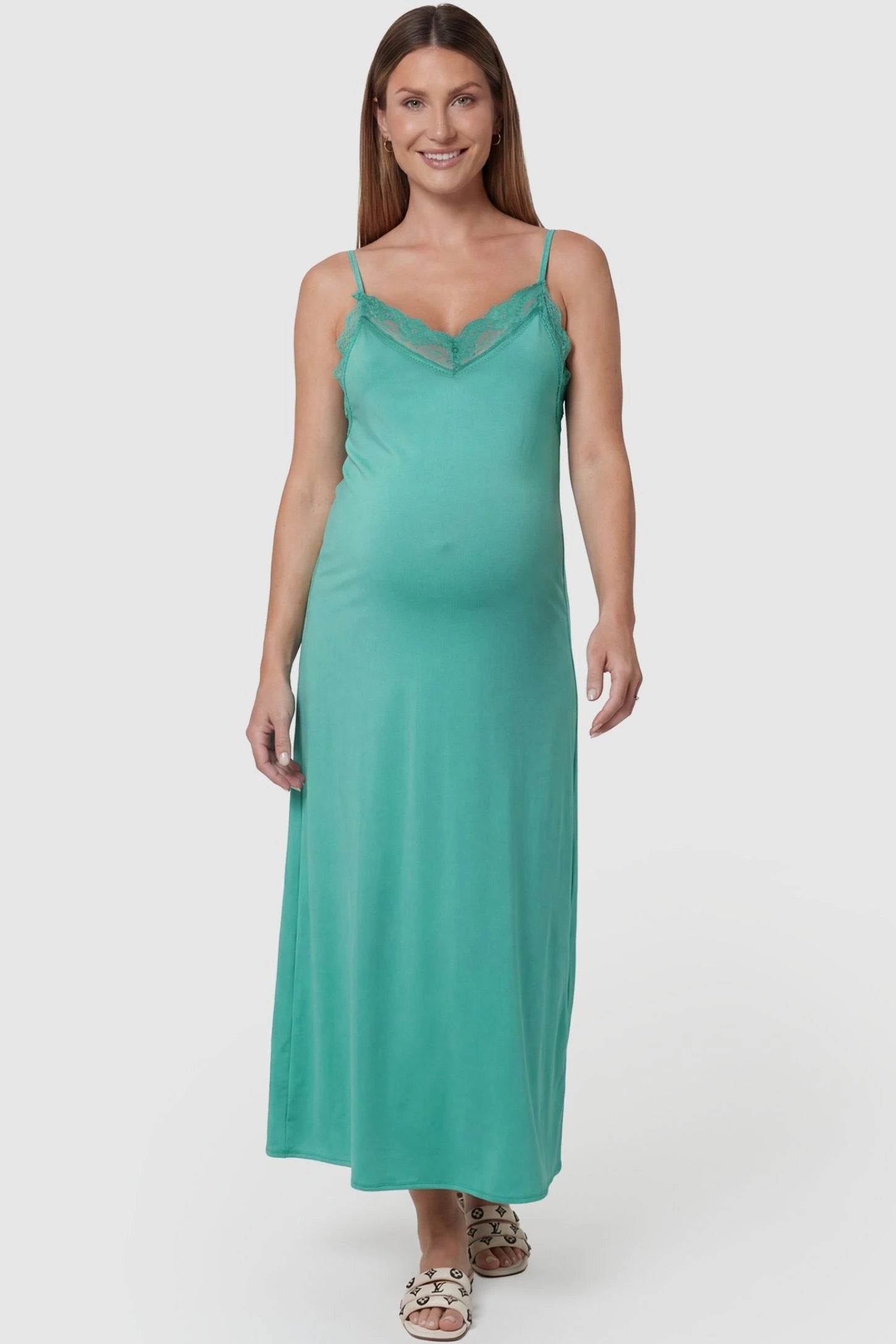 Lace-Trim Maternity Slip Dress in Green featuring delicate spaghetti straps on a pregnant model, front view.