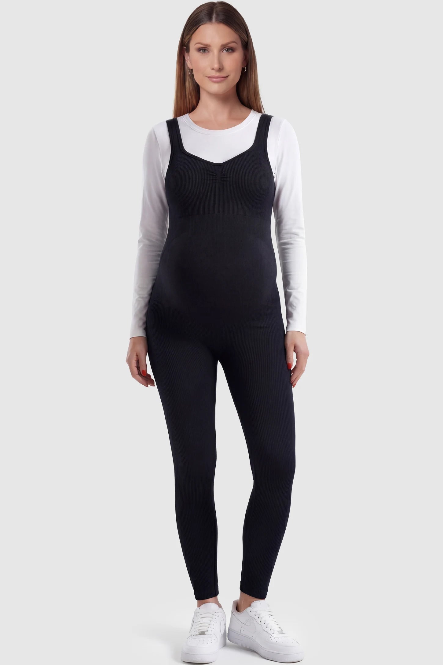 Scoop Neck Sleeveless Ribbed Bodycon Maternity Jumpsuit in Black featuring a seamless stretch fit on a pregnant model.