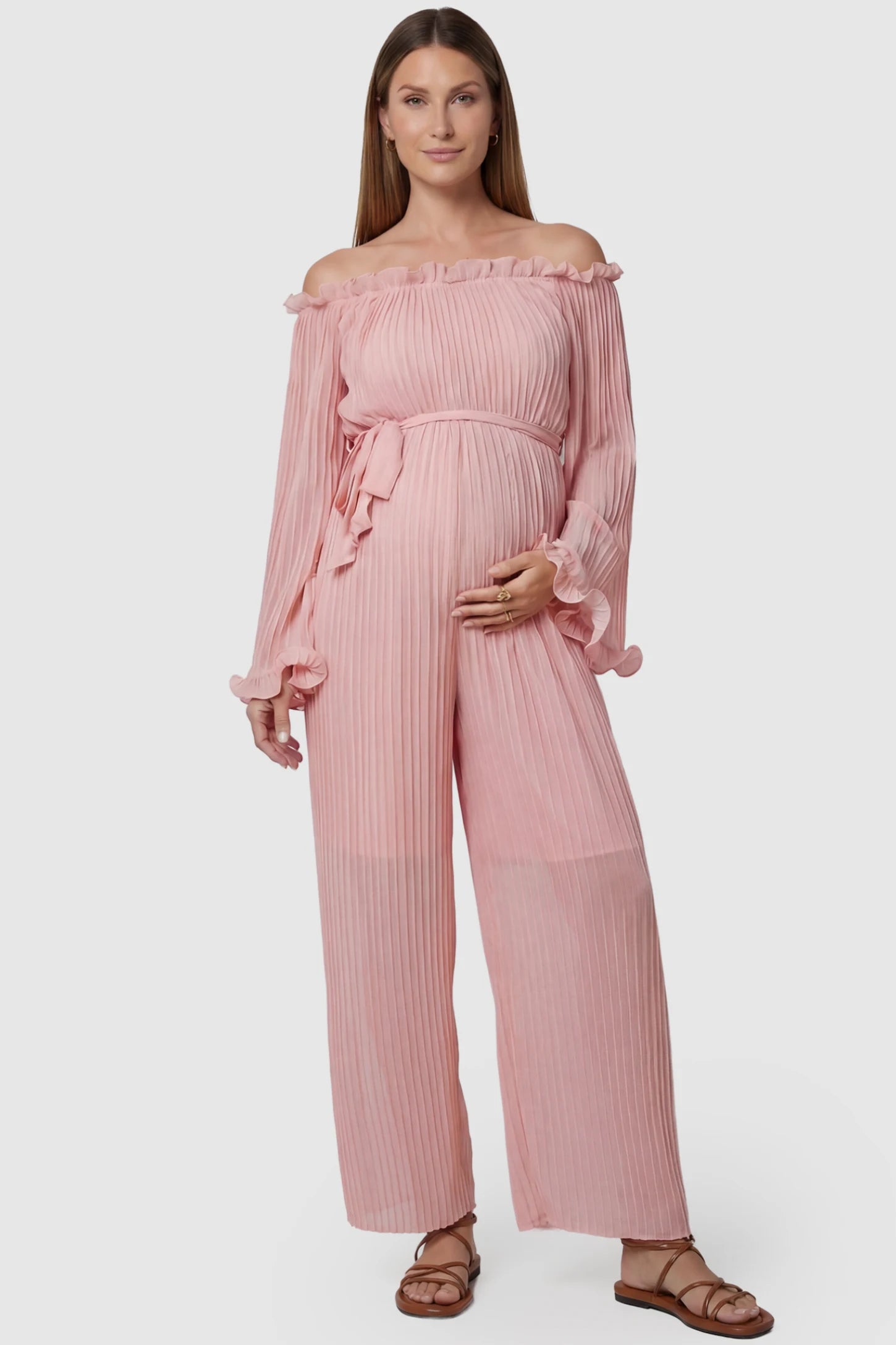 Pleated Off Shoulder Tie-Waist Maternity Jumpsuit in Pink featuring a wide-leg silhouette on a pregnant model, front view.