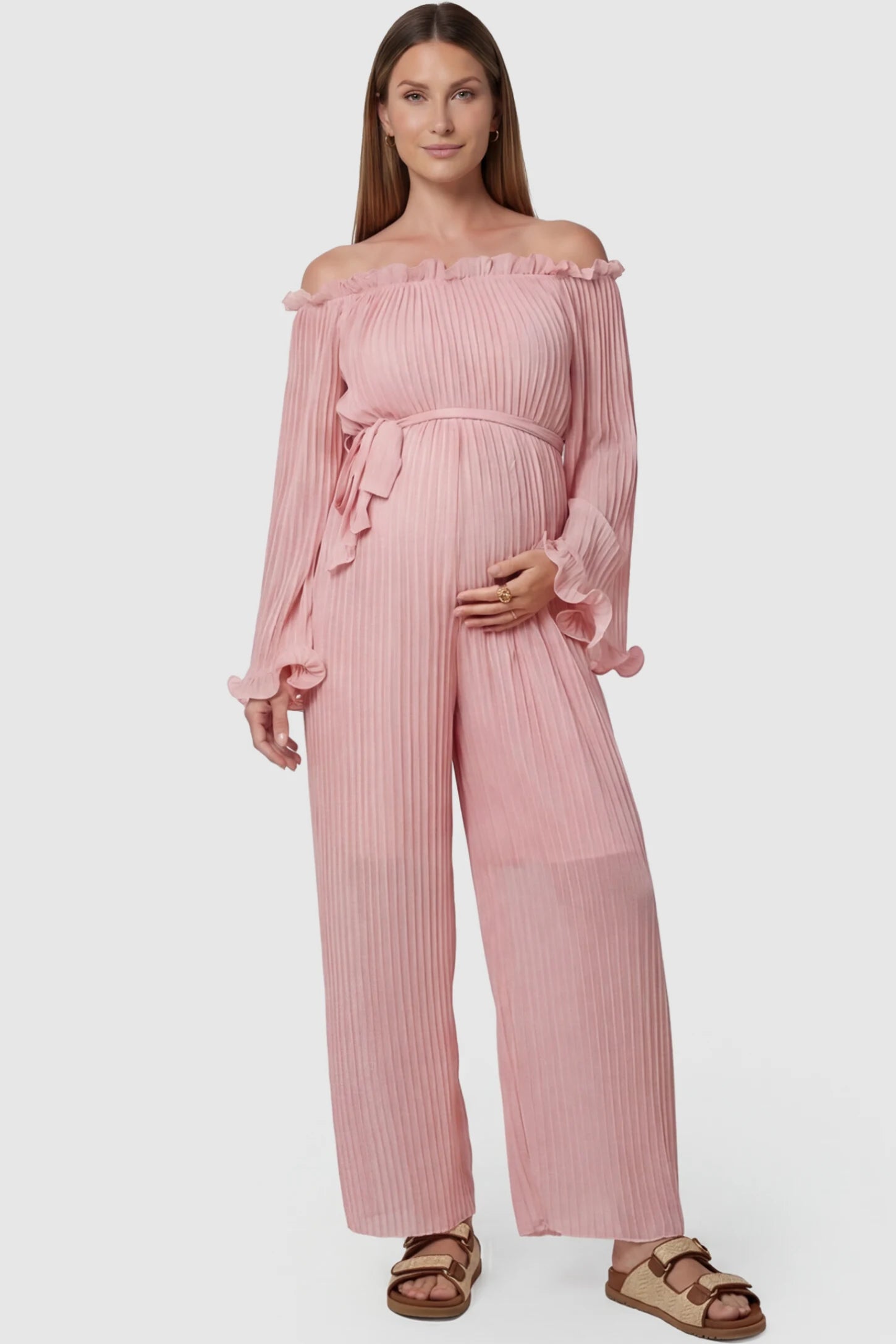 Pleated Off Shoulder Tie-Waist Maternity Jumpsuit in Pink featuring a wide-leg silhouette on a pregnant model, front view.