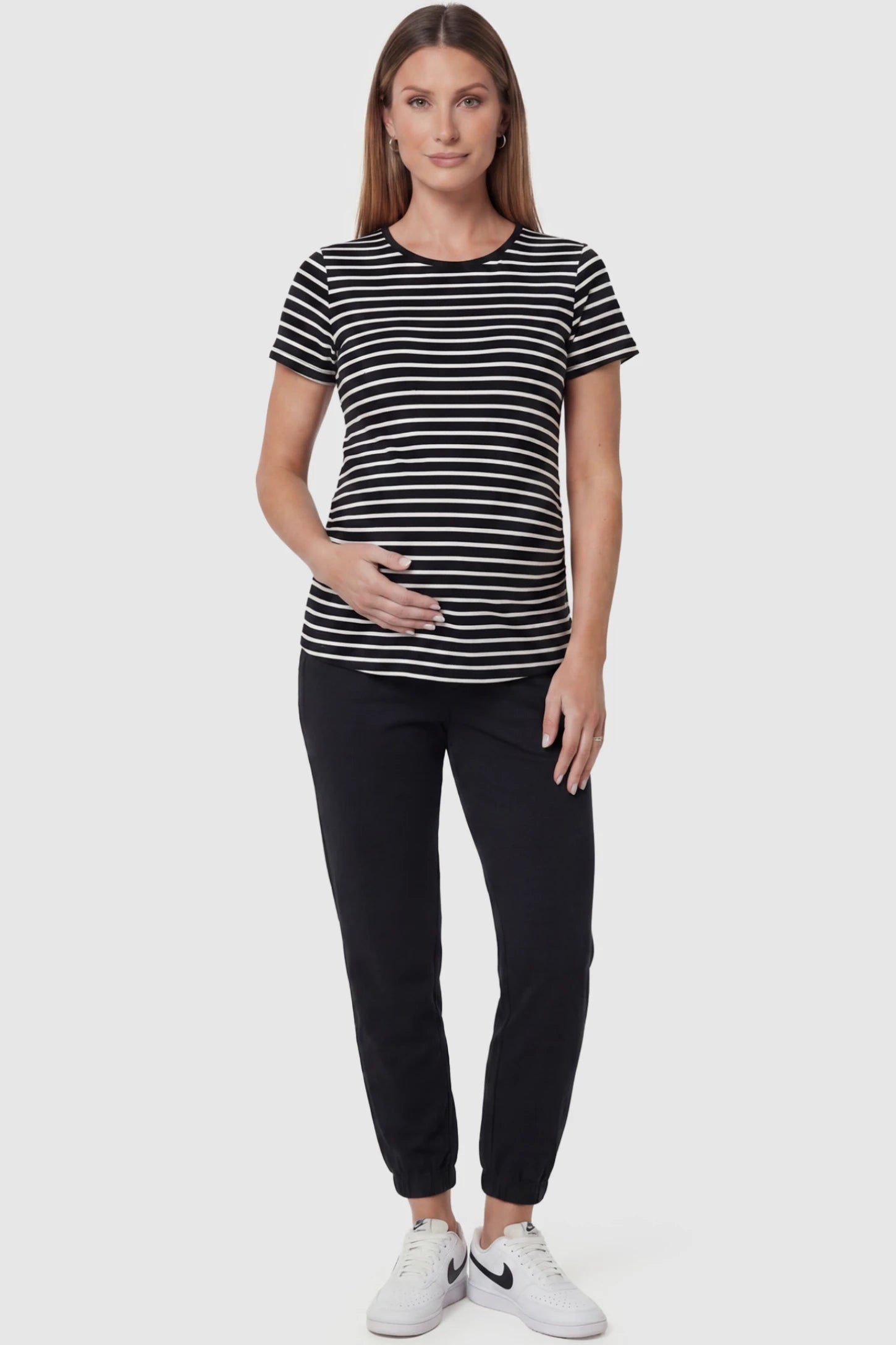 Full Panel Pocketed Maternity Jogger Pants in Black featuring a jersey belly panel on a pregnant model, front view.