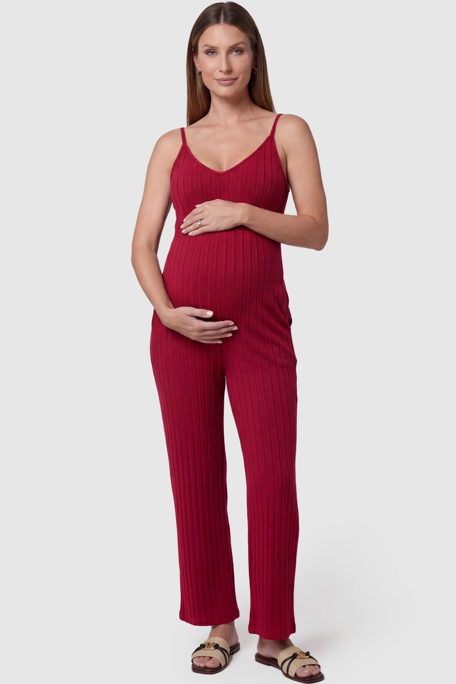 Ribbed Wide-Leg Maternity Camisole Jumpsuit in Red featuring a vertical ribbed texture and relaxed wide leg on a pregnant model, front view.