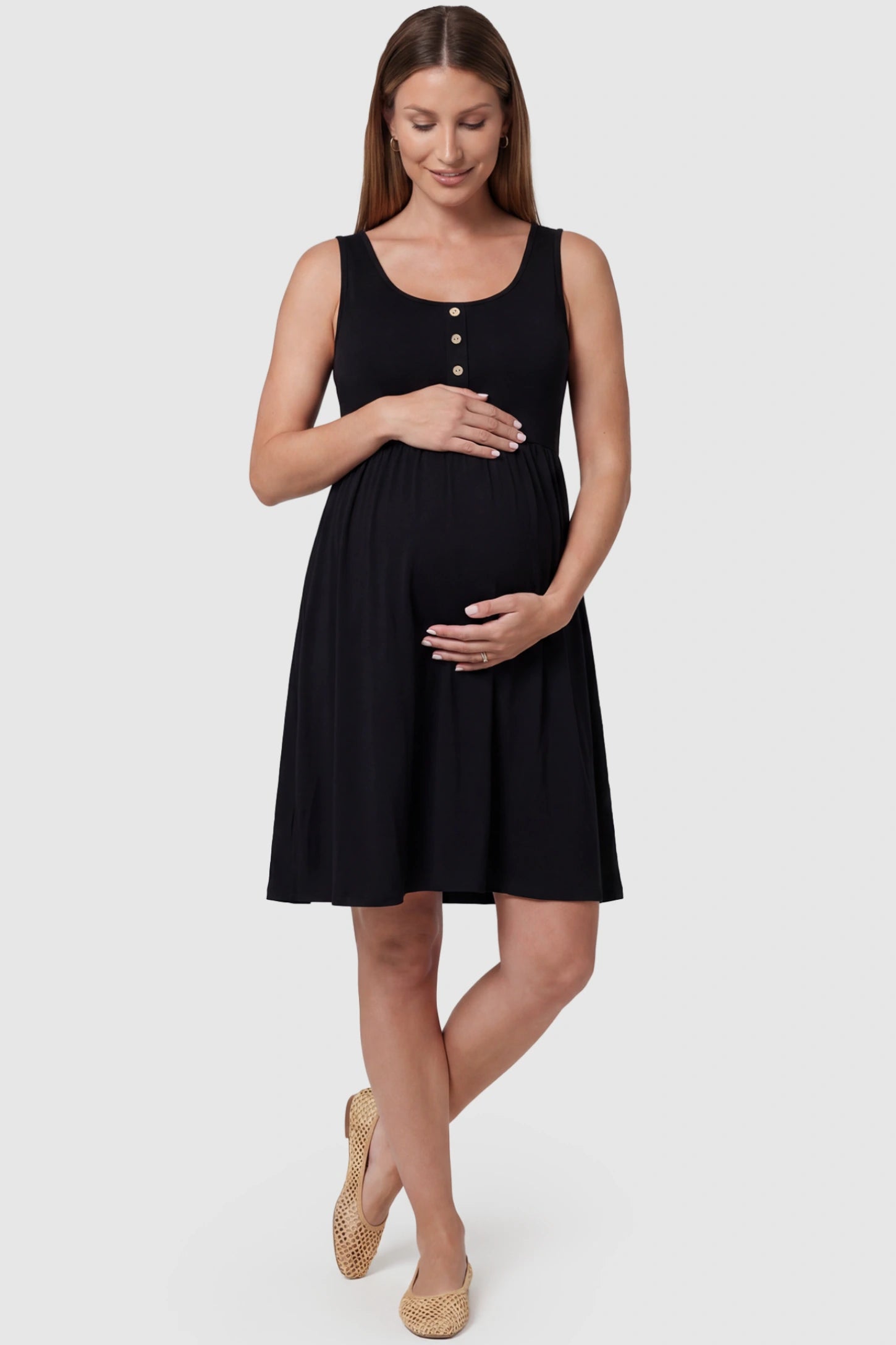 Round Neck Empire Waist Maternity Short Dress in Black featuring soft knit stretch on a pregnant model, front view.