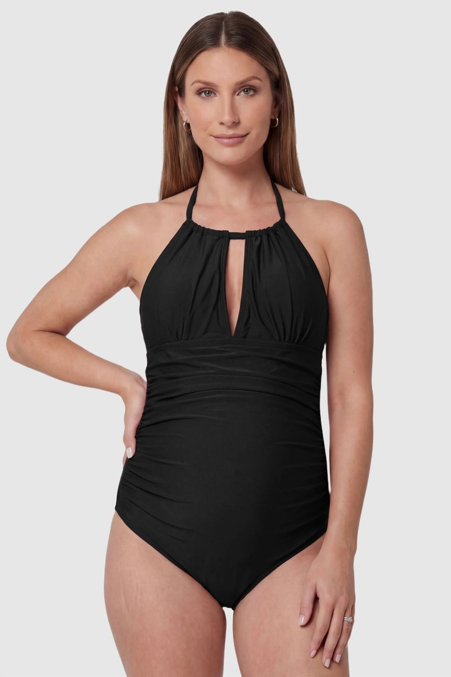 Side-Ruched Halter Maternity One-Piece in Black featuring a chic keyhole cutout on a pregnant model, front view.