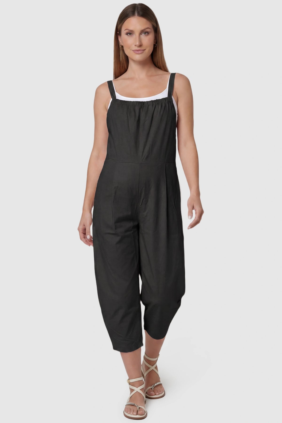 Sleeveless Balloon-Leg Maternity Jumpsuit in Black featuring deep side pockets on a pregnant model, front view.