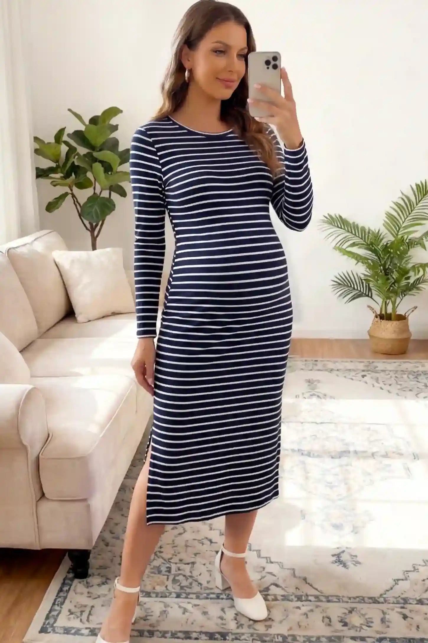 Striped side slit long sleeve bodycon maternity midi dress in black and white featuring a bump-flattering fit on a pregnant model showing front.