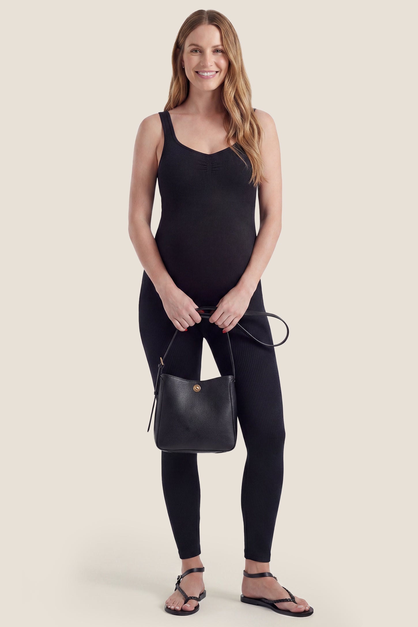 Black scoop neck sleeveless ribbed bodycon maternity jumpsuit styled in a casual lifestyle look