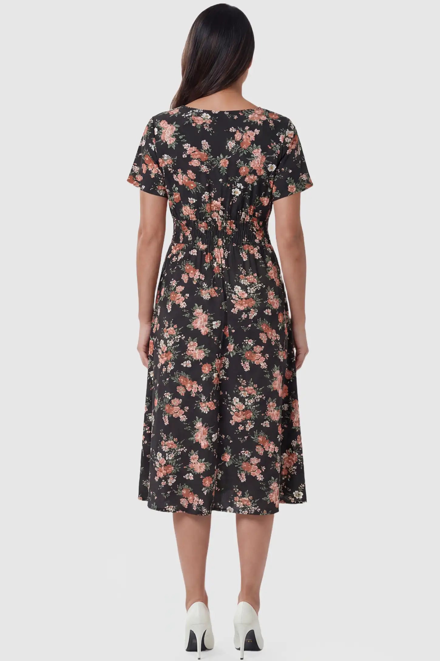 Smocked Waist Crossover Maternity Midi Dress Smocked Waist Crossover Maternity Midi Dress in black floral print featuring smocked bodice and A-line midi skirt on pregnant model.