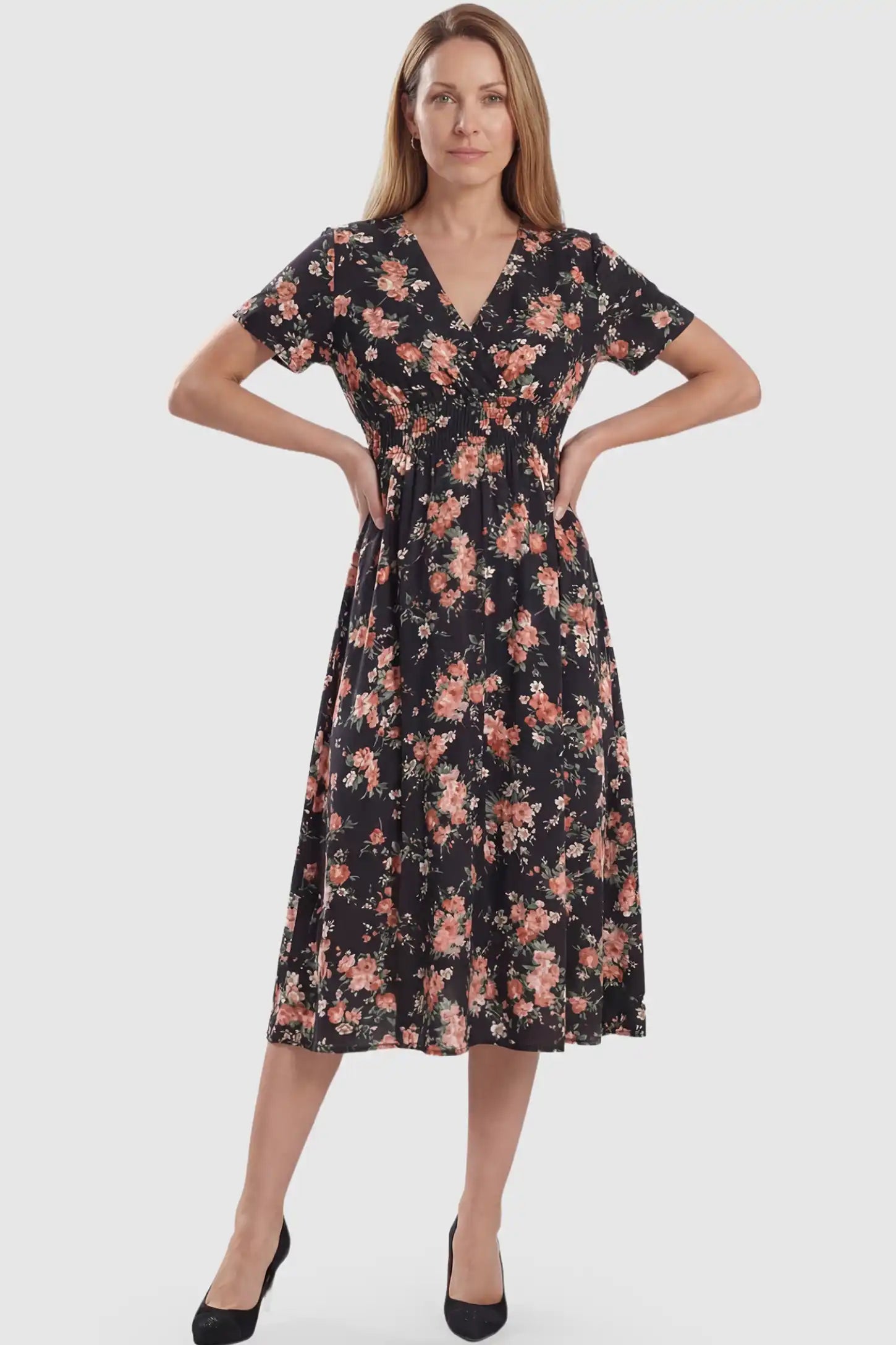 Smocked Waist Crossover Maternity Midi Dress Smocked Waist Crossover Maternity Midi Dress in black floral print featuring V-neck wrap bodice and A-line midi skirt on non pregnant model.