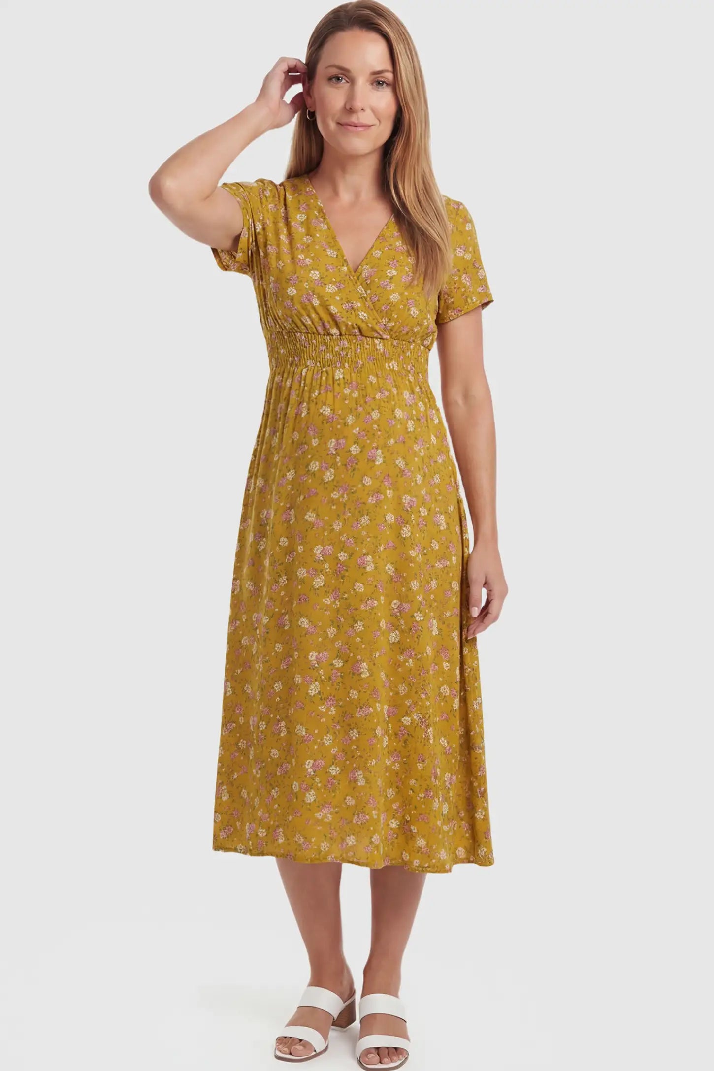 Smocked Waist Crossover Maternity Midi Dress Smocked Waist Crossover Maternity Midi Dress in yellow floral print featuring V-neck wrap bodice and A-line midi skirt on non pregnant model.