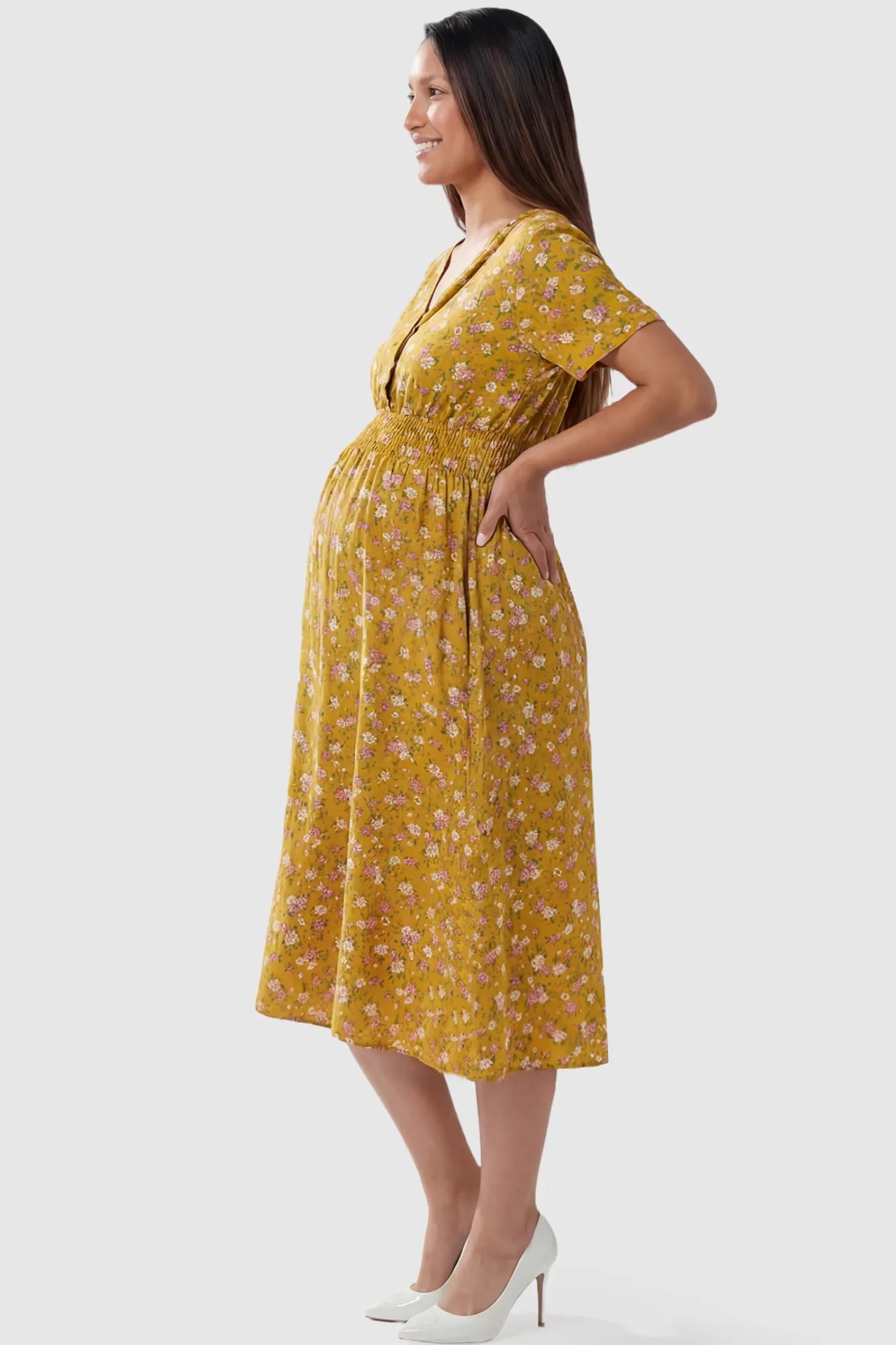Smocked Waist Crossover Maternity Midi Dress in yellow floral print featuring V-neck wrap bodice and A-line midi skirt on pregnant model.
