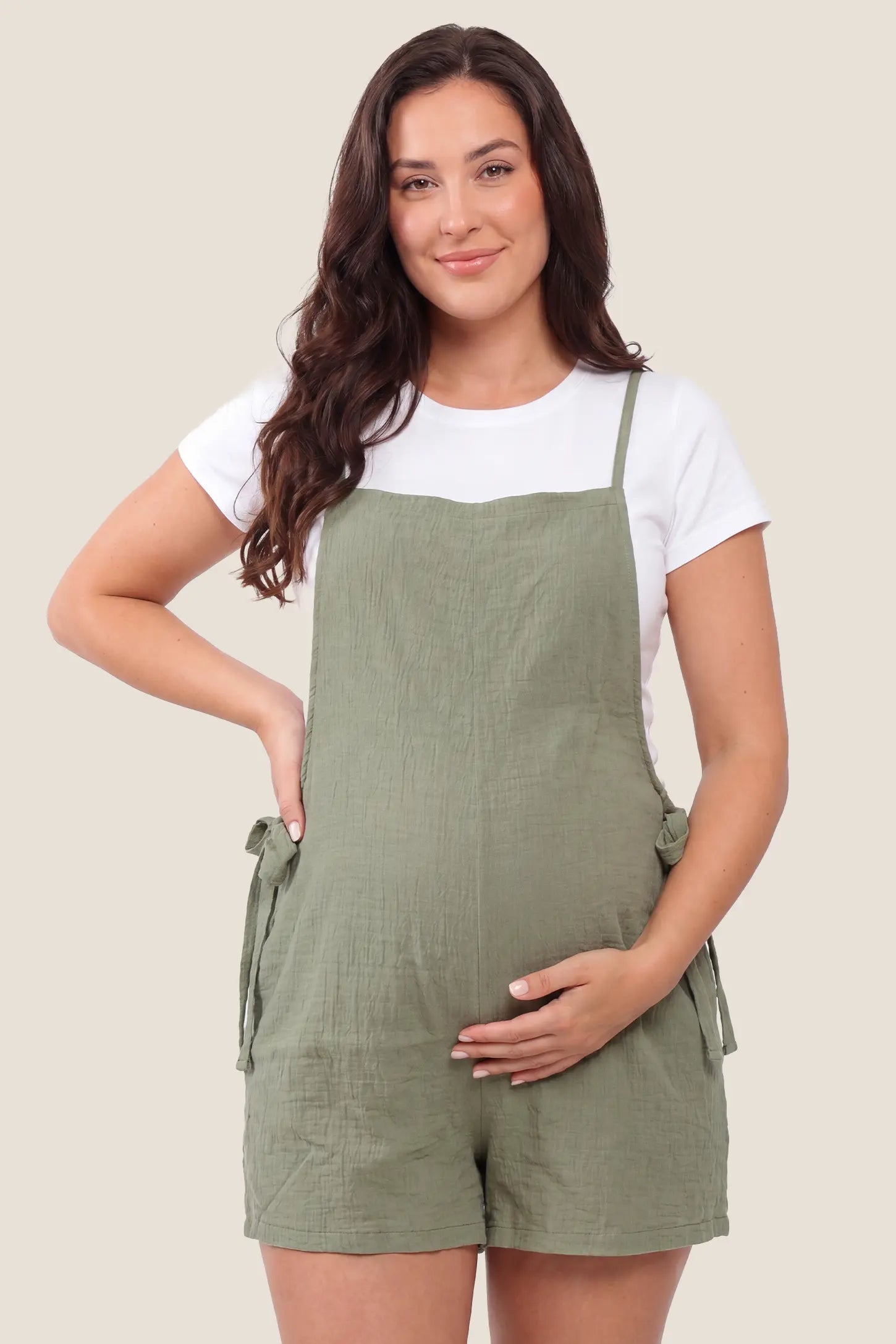 Spaghetti Strap Tie-Side Maternity Romper in Green featuring a square neckline on a front-facing pregnant model.