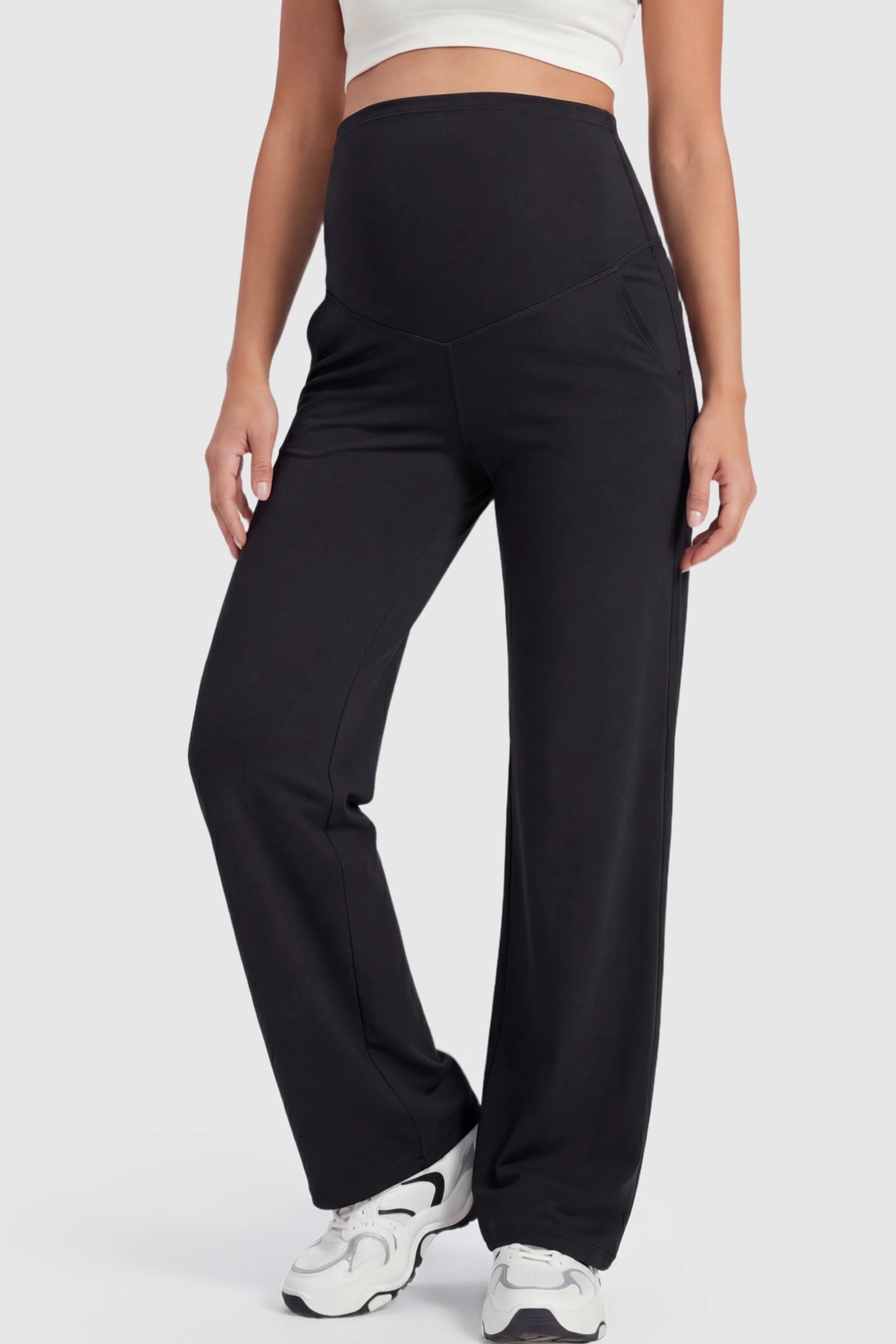 Full Panel High Waist Wide Leg Maternity Pants in Black featuring a supportive expansion-waist on a pregnant model showing front.