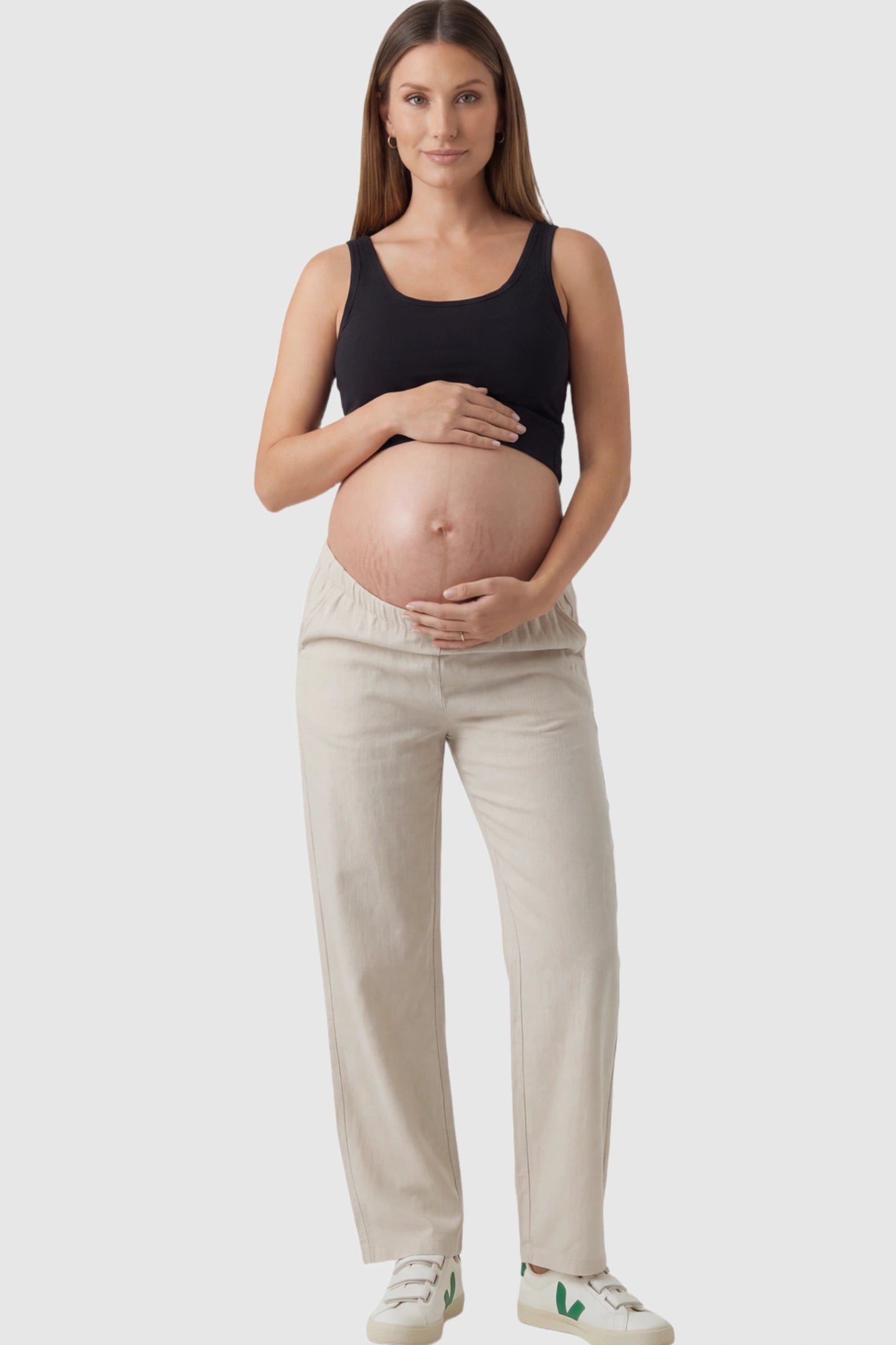 Adjustable Elastic Waist Wide Leg Maternity Pants Adjustable Elastic Waist Wide-Leg Maternity Pants in Beige featuring a customizable button-hole waistband on a pregnant model facing front.
