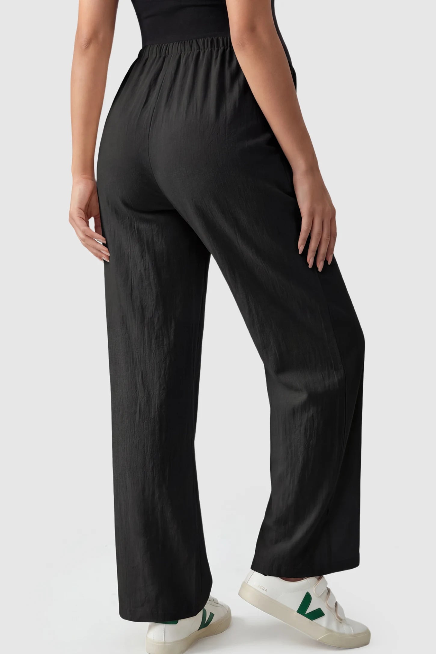 Adjustable Elastic Waist Wide Leg Maternity Pants Adjustable Elastic Waist Wide-Leg Maternity Pants in Black featuring a customizable button-hole waistband on a pregnant model showing back.