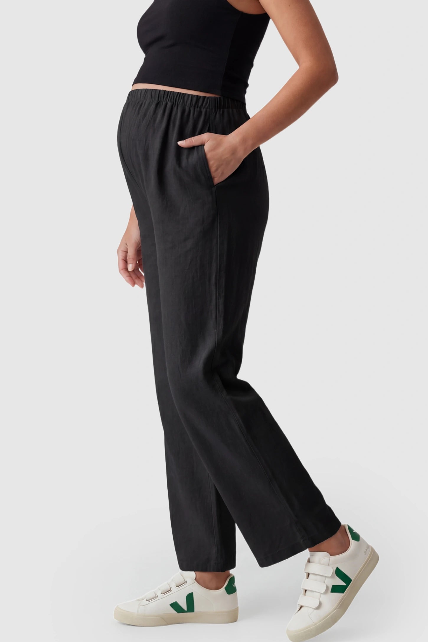 Adjustable Elastic Waist Wide Leg Maternity Pants Adjustable Elastic Waist Wide-Leg Maternity Pants in Black featuring a customizable button-hole waistband on a pregnant model showing side.
