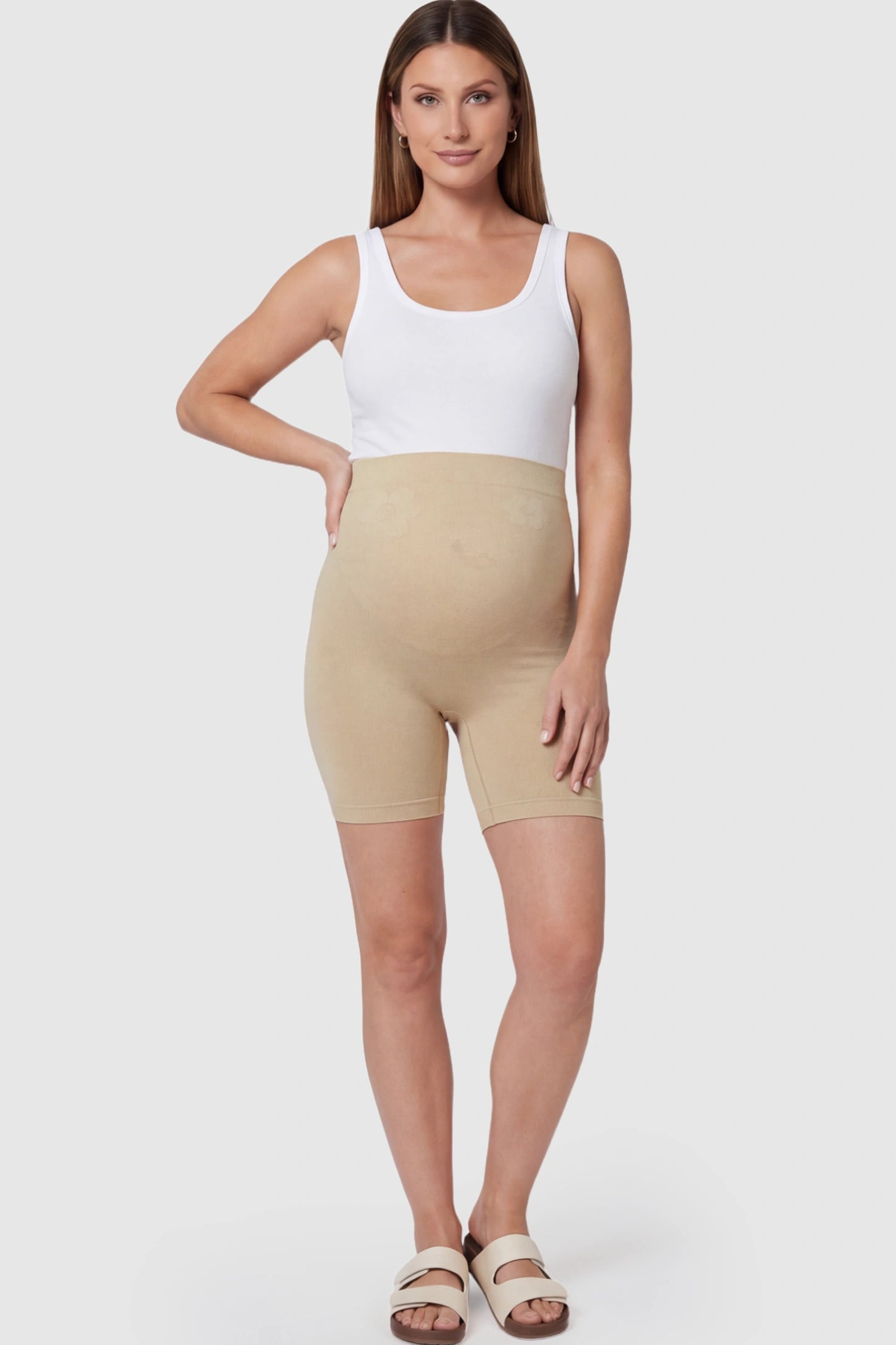 Seamless High-Waisted Mid Thigh Maternity Shapewear Shorts in Nude featuring a smooth belly support panel on a pregnant model.