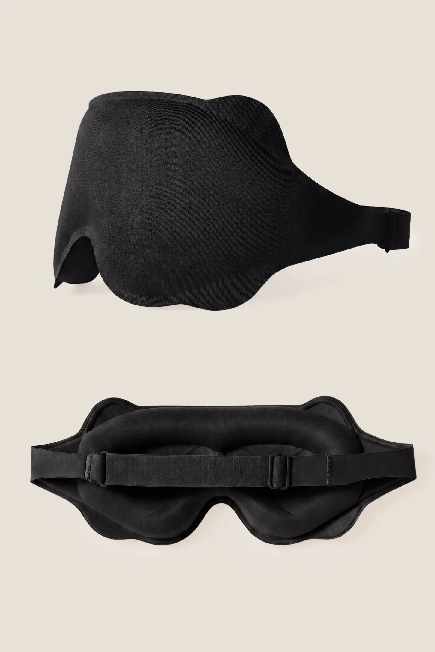 3D Contoured Blackout Sleep Mask 3D Contoured Blackout Sleep Mask in Black featuring dual-angle display of the seamless 3D front mold and the adjustable elastic strap with cushioned inner contour, studio product view.
