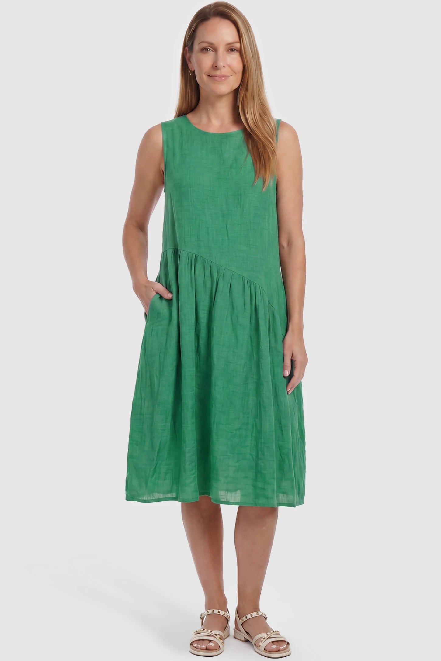 Sleeveless Pocketed A-Line Maternity Midi Dress Sleeveless pocketed A-line maternity midi dress in green with sleeveless cut, front view on postpartum model