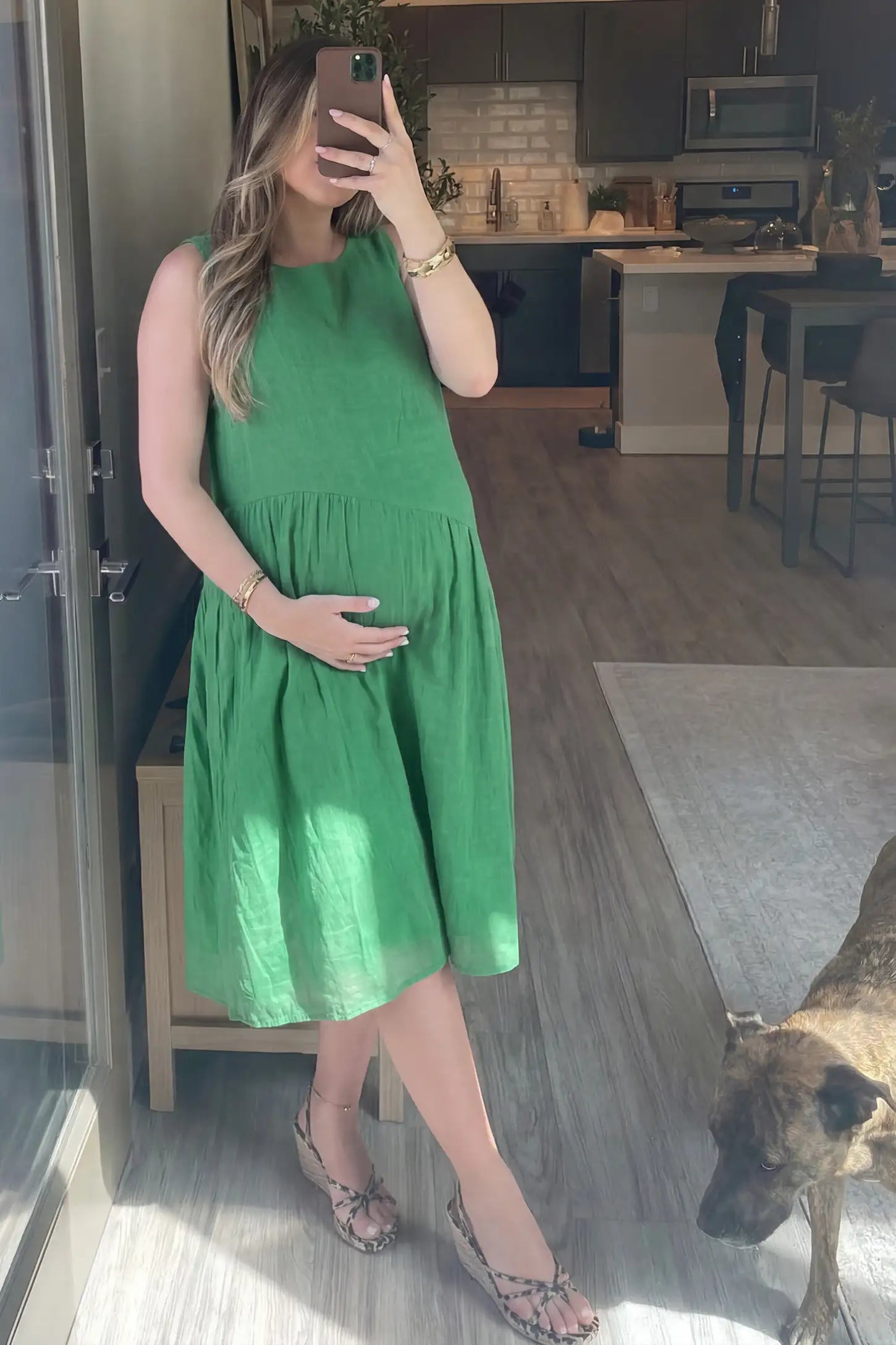 Sleeveless Pocketed A-Line Maternity Midi Dress Sleeveless pocketed A-line maternity midi dress in green with sleeveless cut, front view on pregnant model