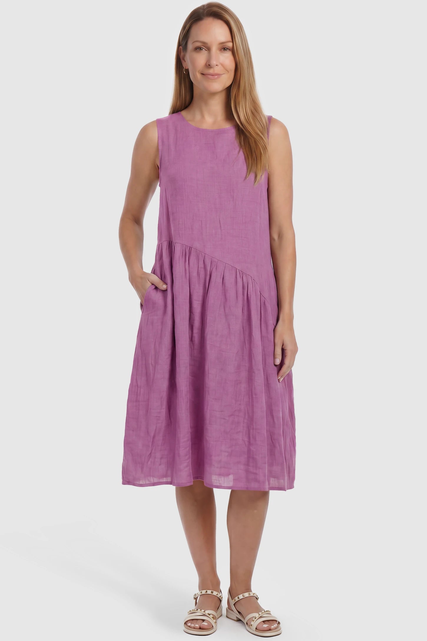 Sleeveless Pocketed A-Line Maternity Midi Dress Sleeveless pocketed A-line maternity midi dress in pink with sleeveless cut, front view on postpartum model