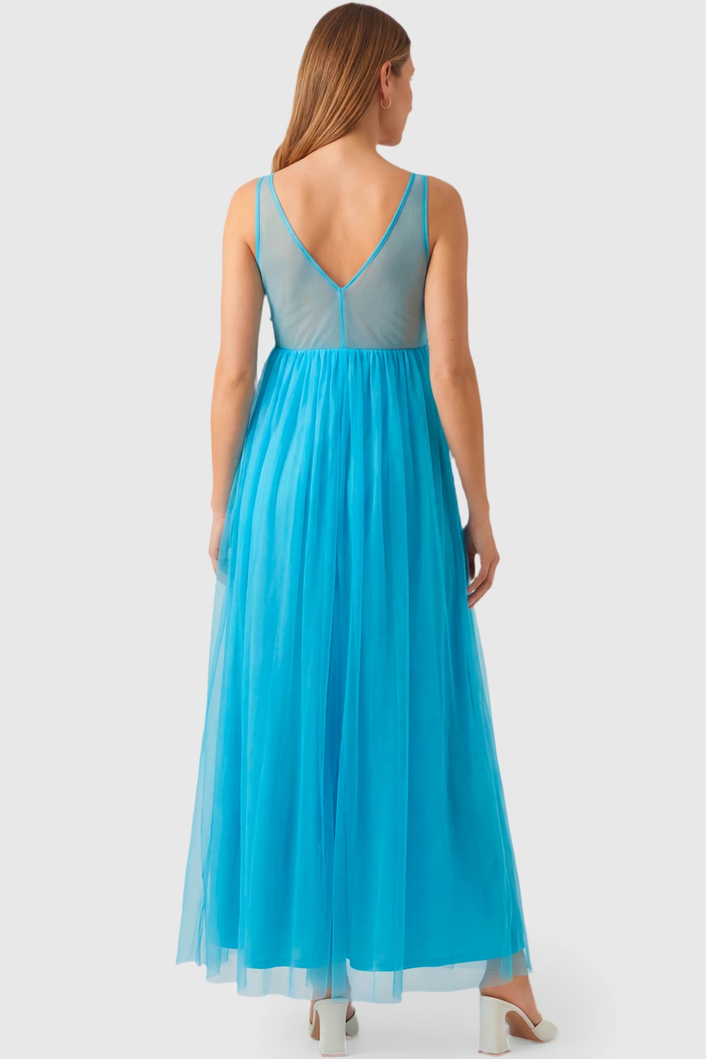 Sleeveless A-line Maternity Gown Sleeveless A-line Maternity Gown in peacock blue featuring lace-trimmed V-neck and empire waist on pregnant model.